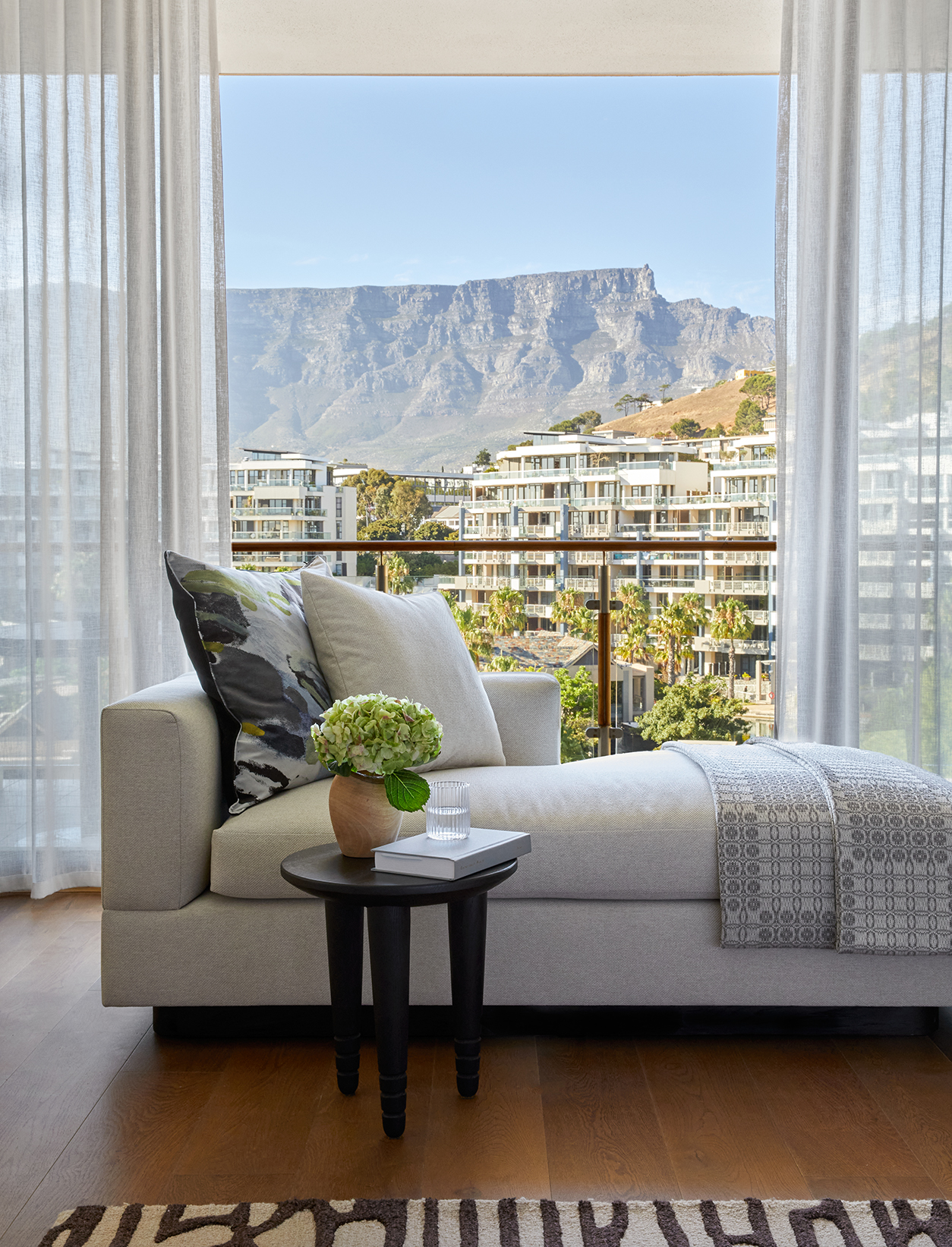 Africa, South Africa, One&Only Cape Town, chaise lounge in front of balcony in the marina grand suite 