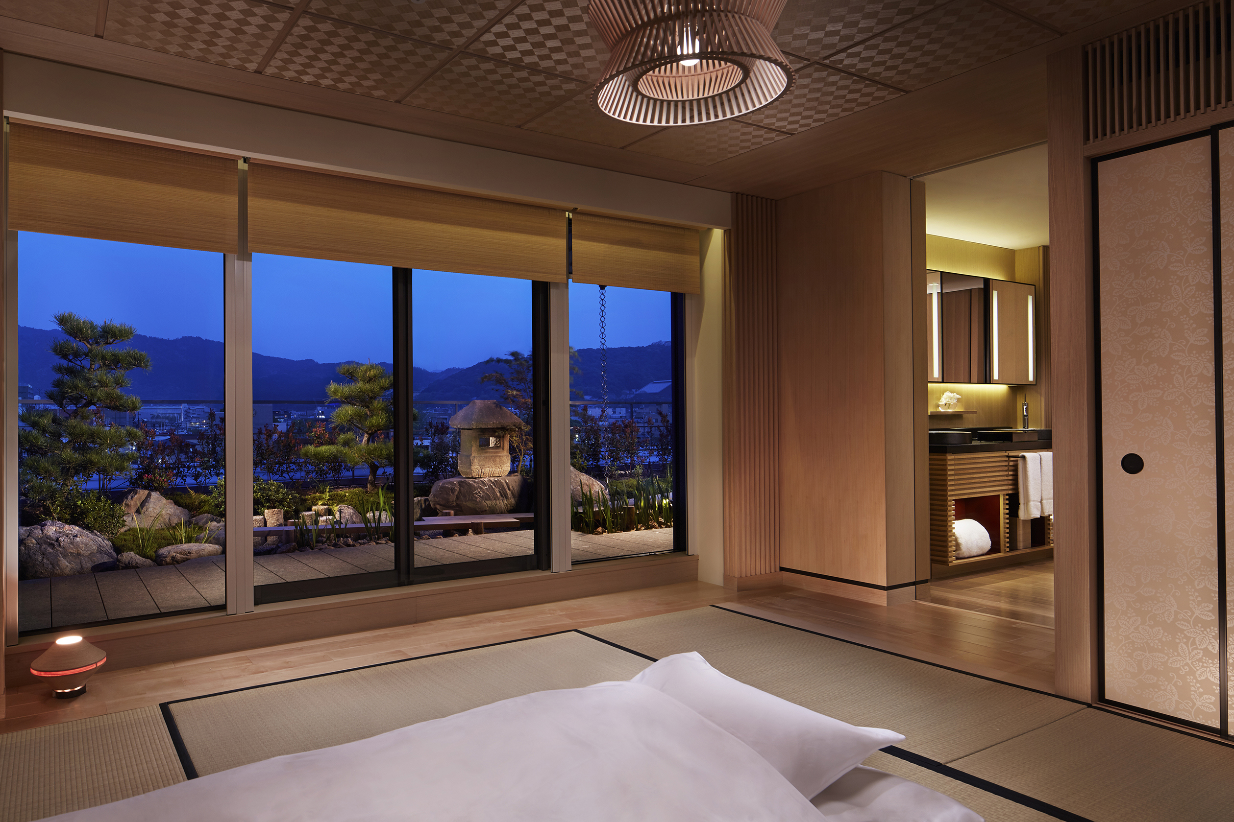 The tatami bedroom of a suite decorated in neutral tones that overlooks pretty gardens 