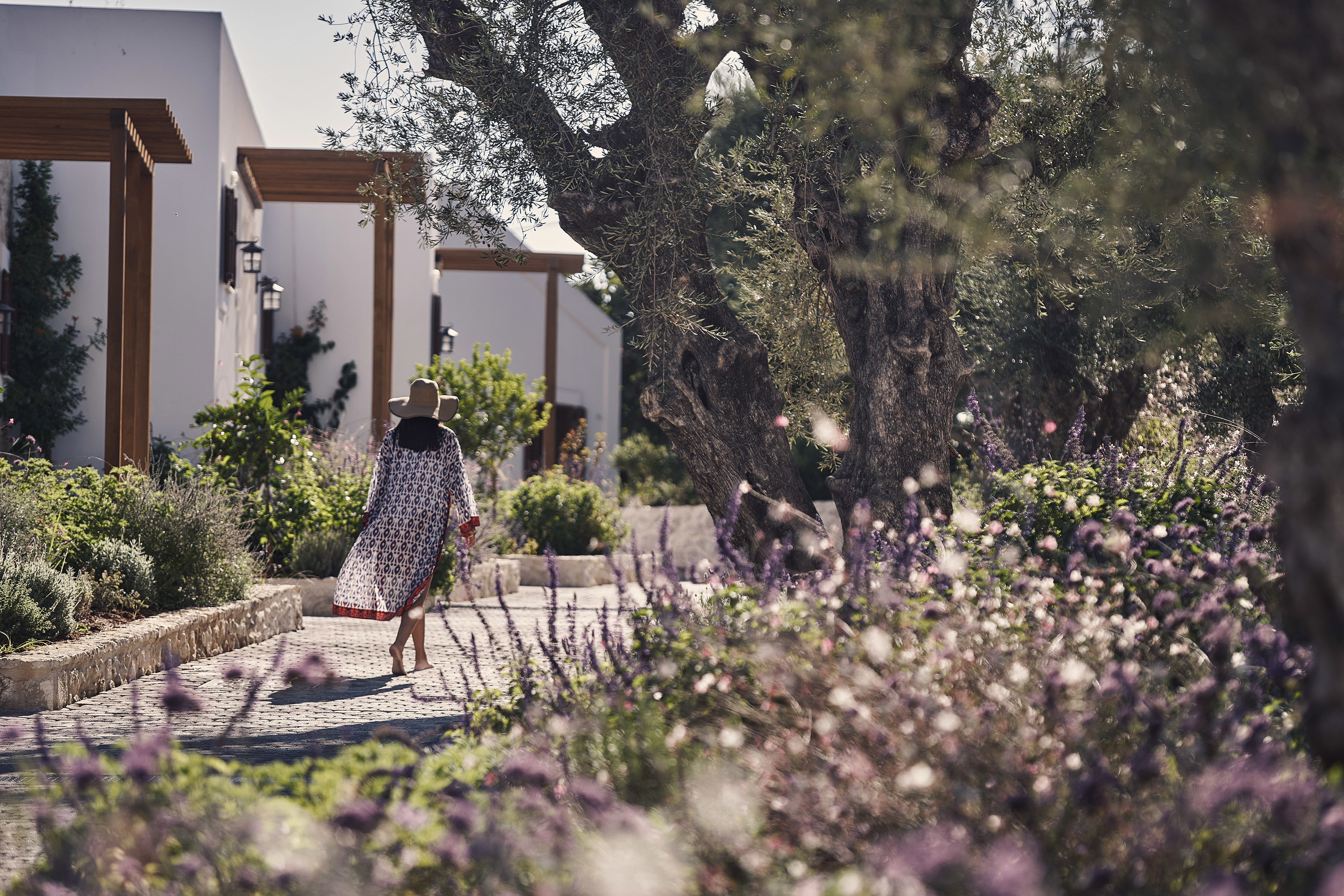 Woman in black and white patterned kimono walking along the pathways of Lesante Cape