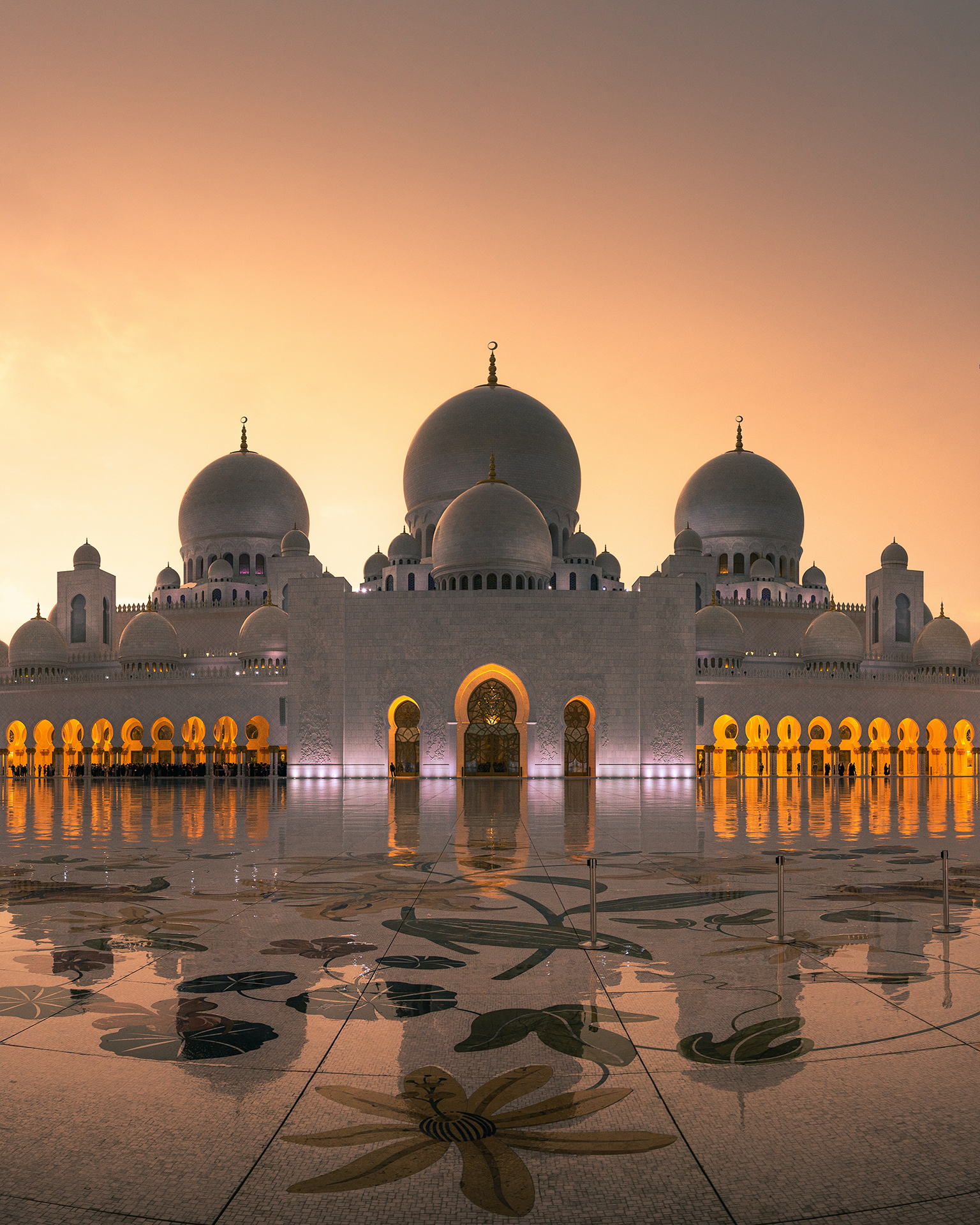 a large building with domes and a reflection on the floor