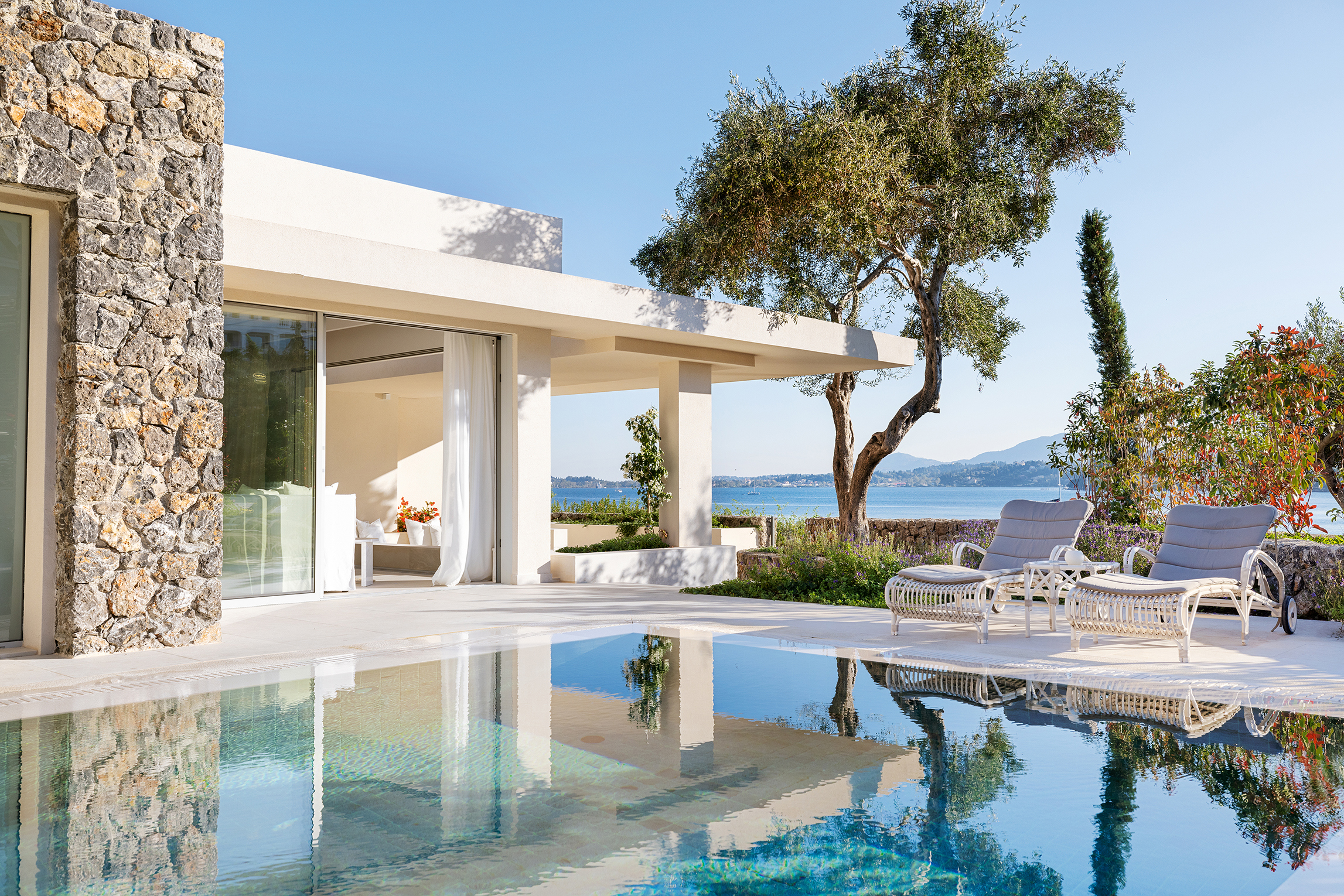 Luxury bungalow suite at Grecotel Corfu Imperial with private pool, sun loungers, and panoramic sea views.
