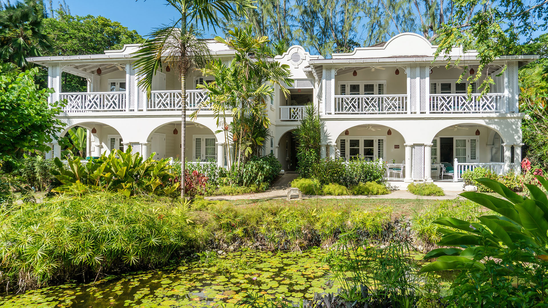 Exterior of the white main house with its traditional features at Coral Reef Club