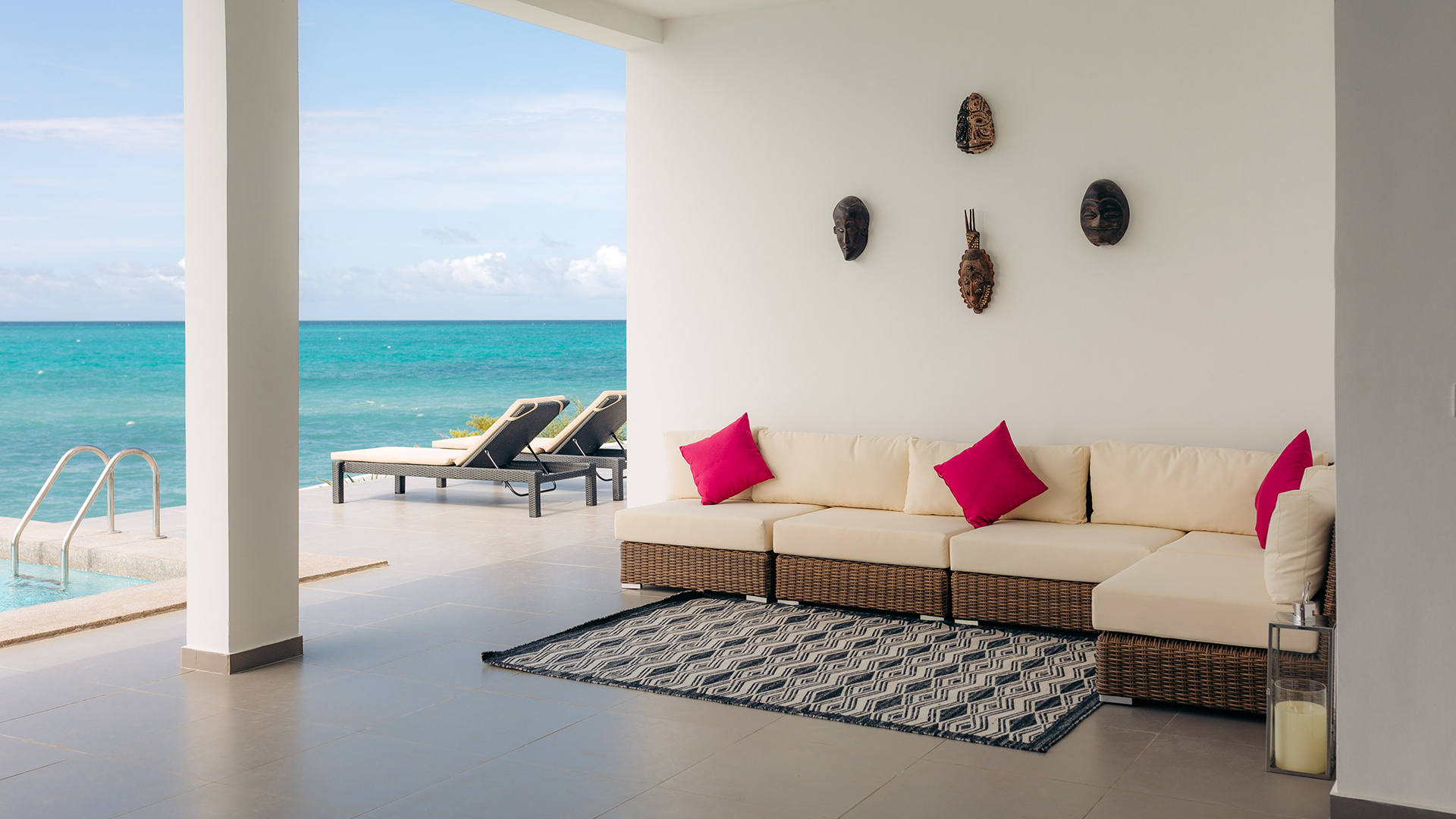 Seating and loungers by the sea at SafiraBlue - Luxury Resort and Villas