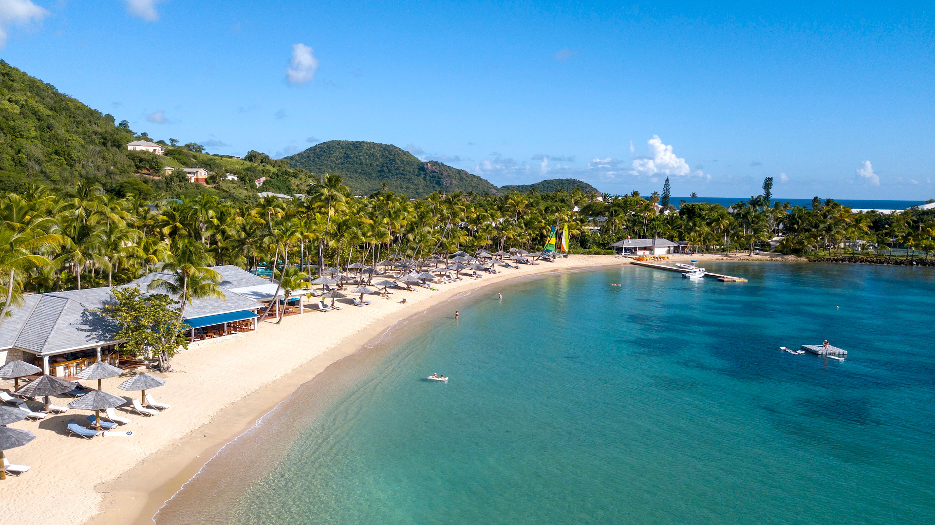 Curtain Bluff Beach with a boat dock and beach cabanas