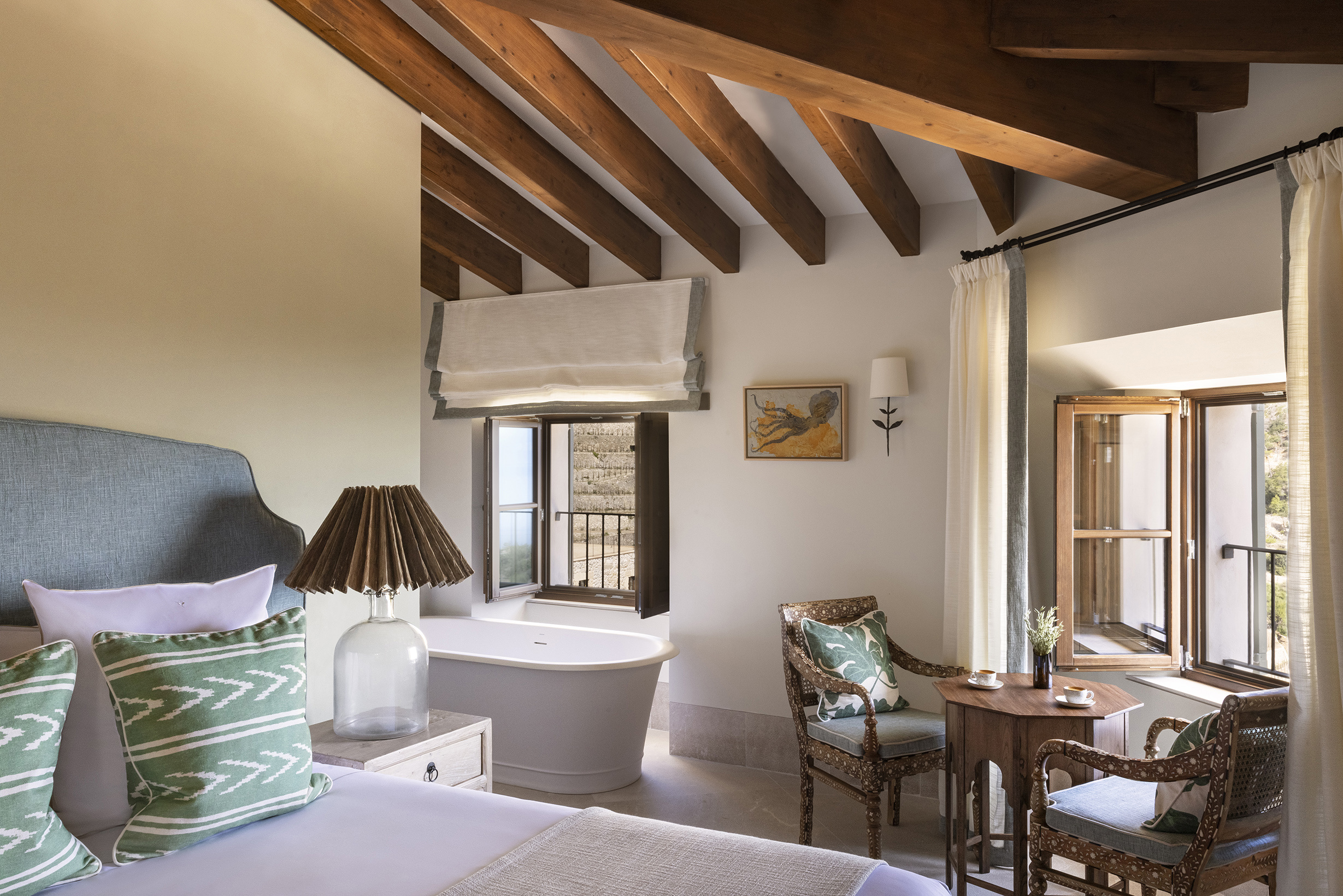 Details of sea view room including original beams, bath tub and breakfast seating area