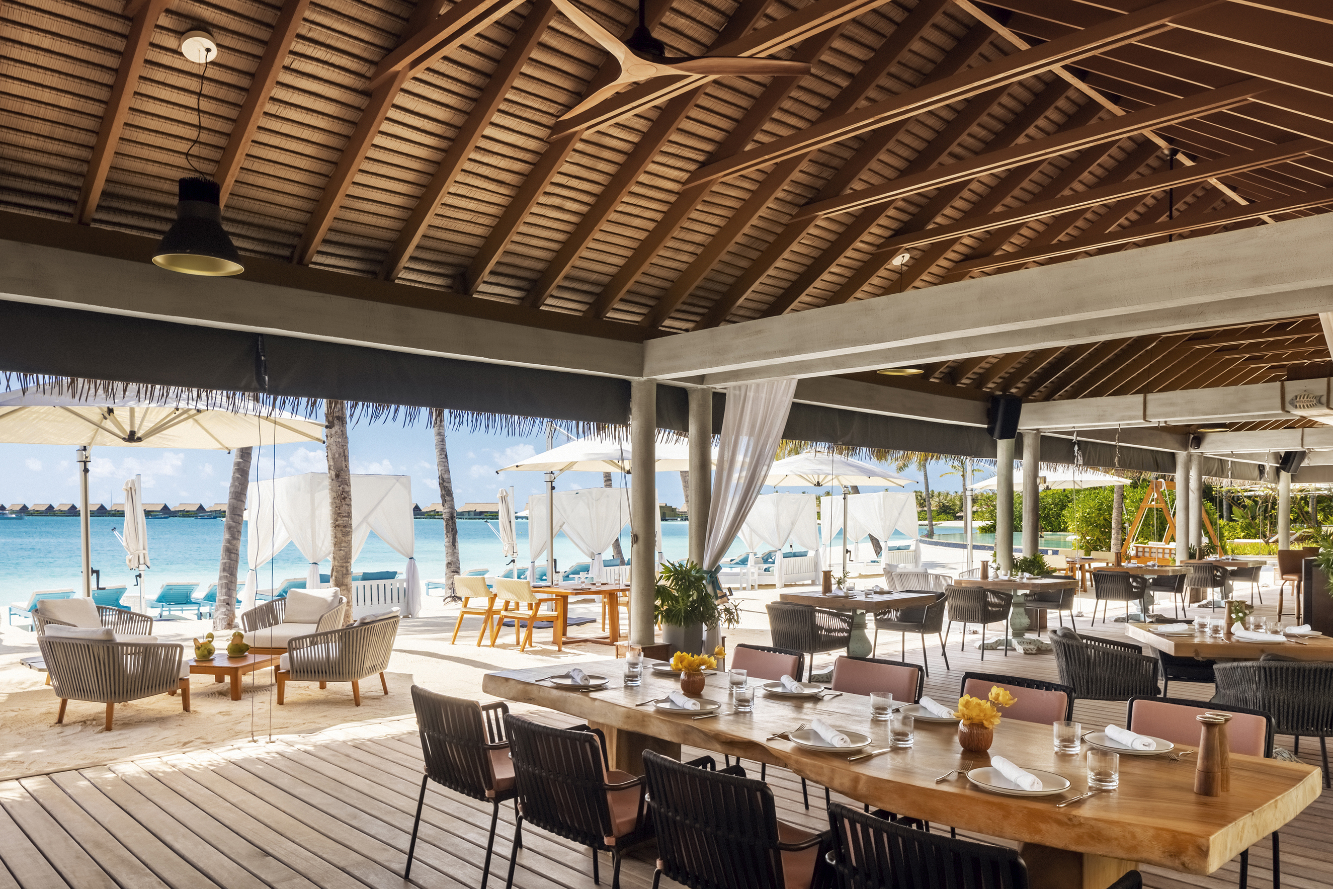 Tables on the inside and terrace of Nava Restaurant set for lunch 