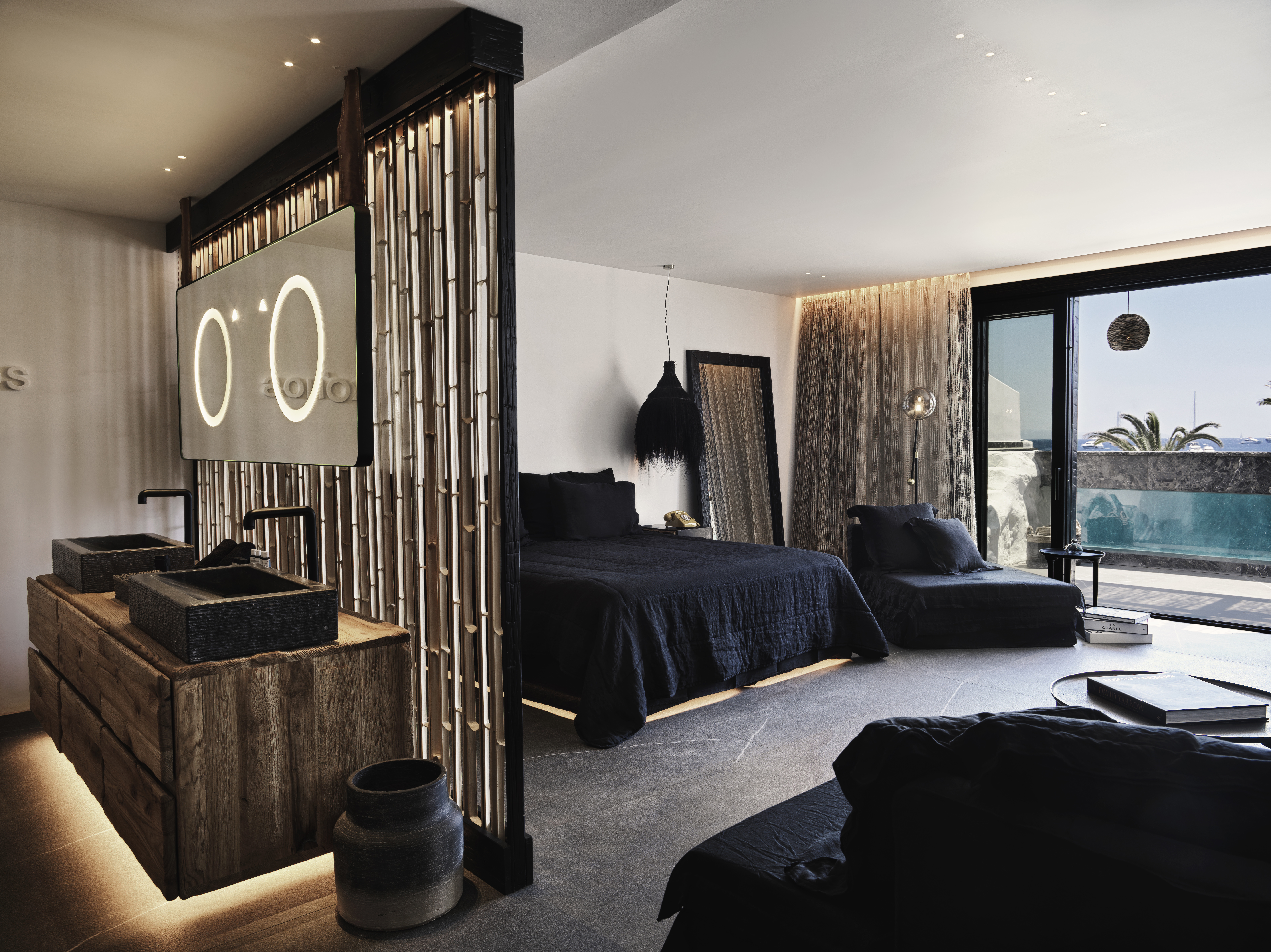 Bed and bathroom sinks inside the O! Suite at Myconian O