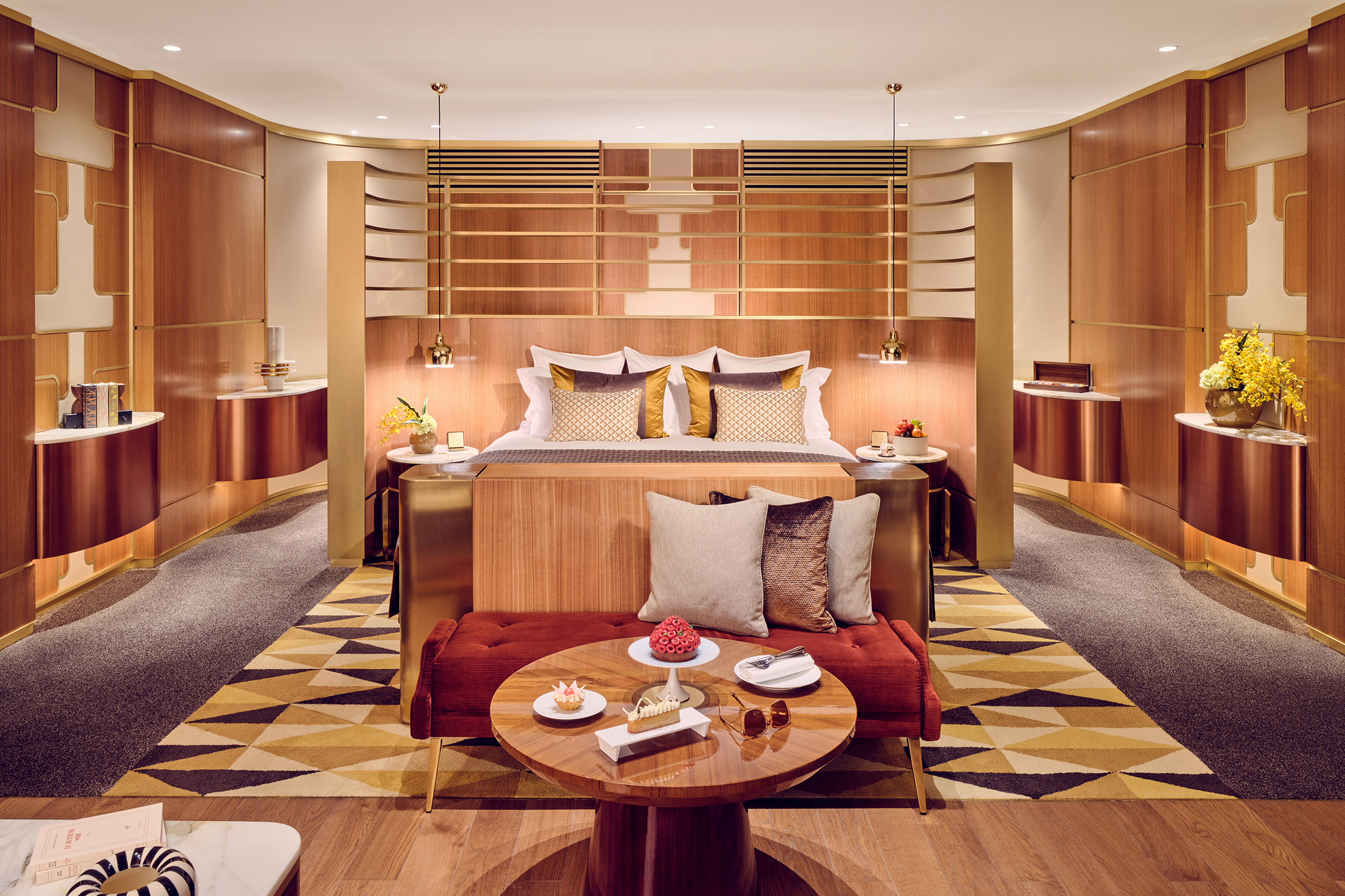 An art deco inspired suite at Royal Mansour Casablanca with a plush bed, ornate walls and polished wood furniture