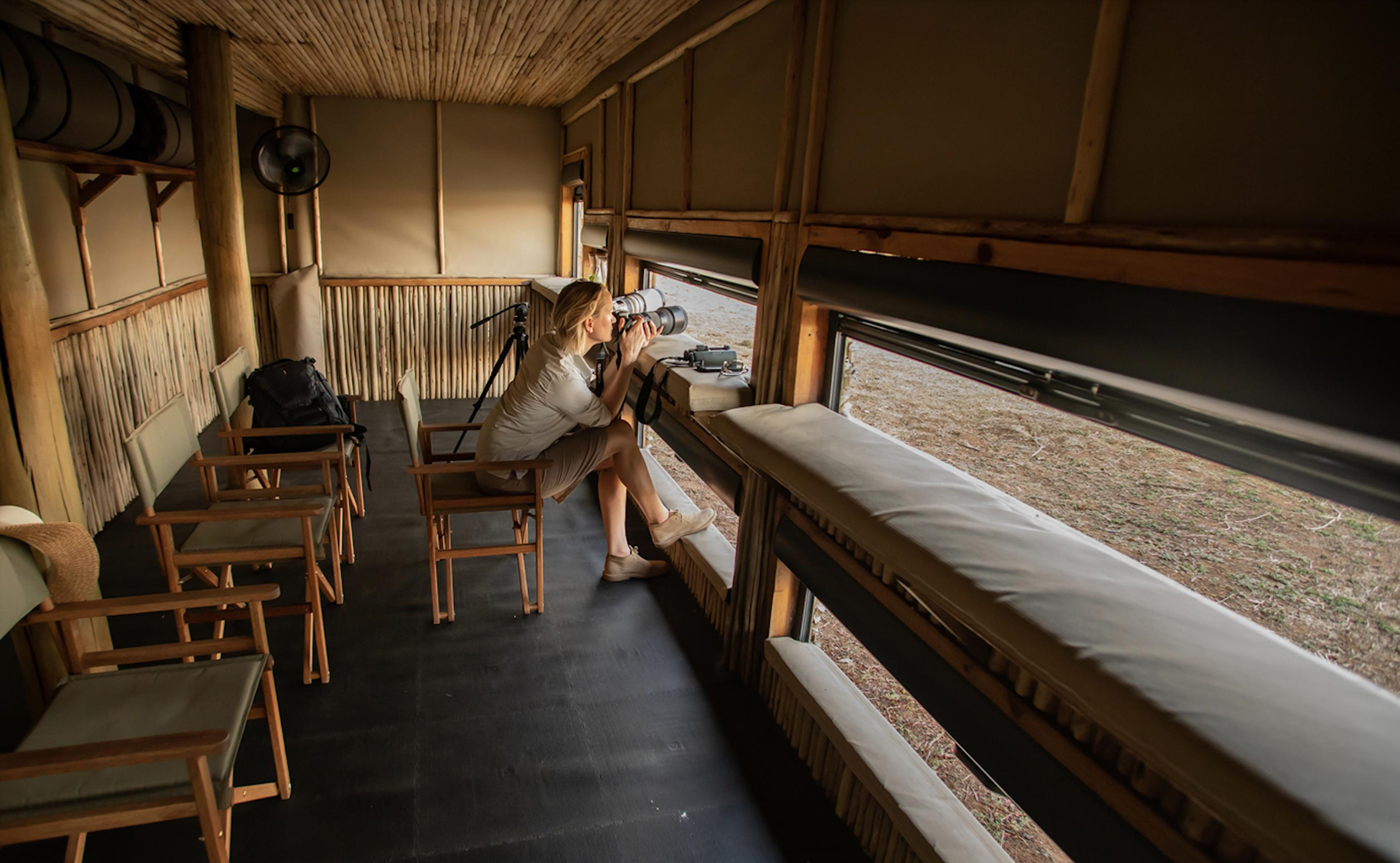 Africa, Zambia, South Luangwa National Park, Puku Ridge Camp, photographer in photography hide
