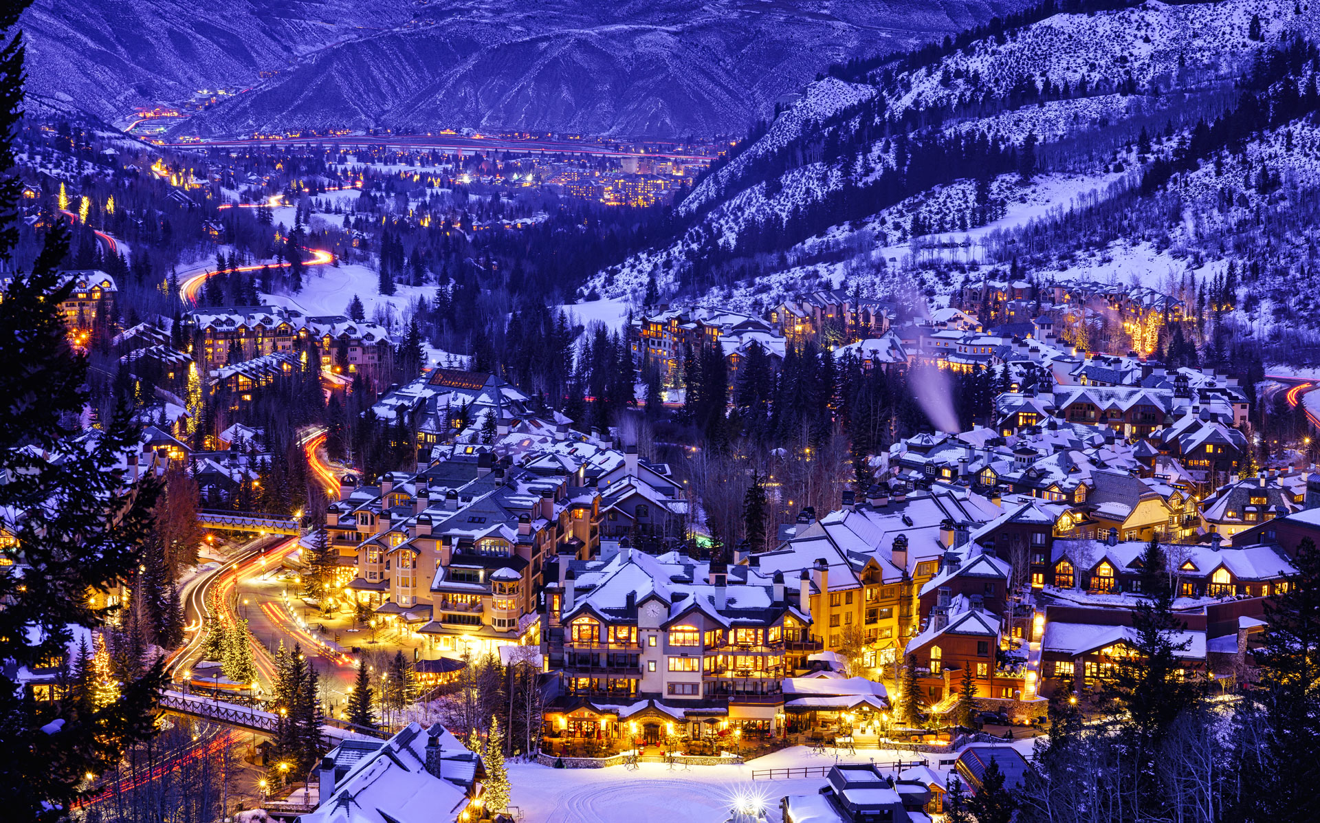 Dusk view at twilight of village lights and town at night in winter looking down from ski slopes