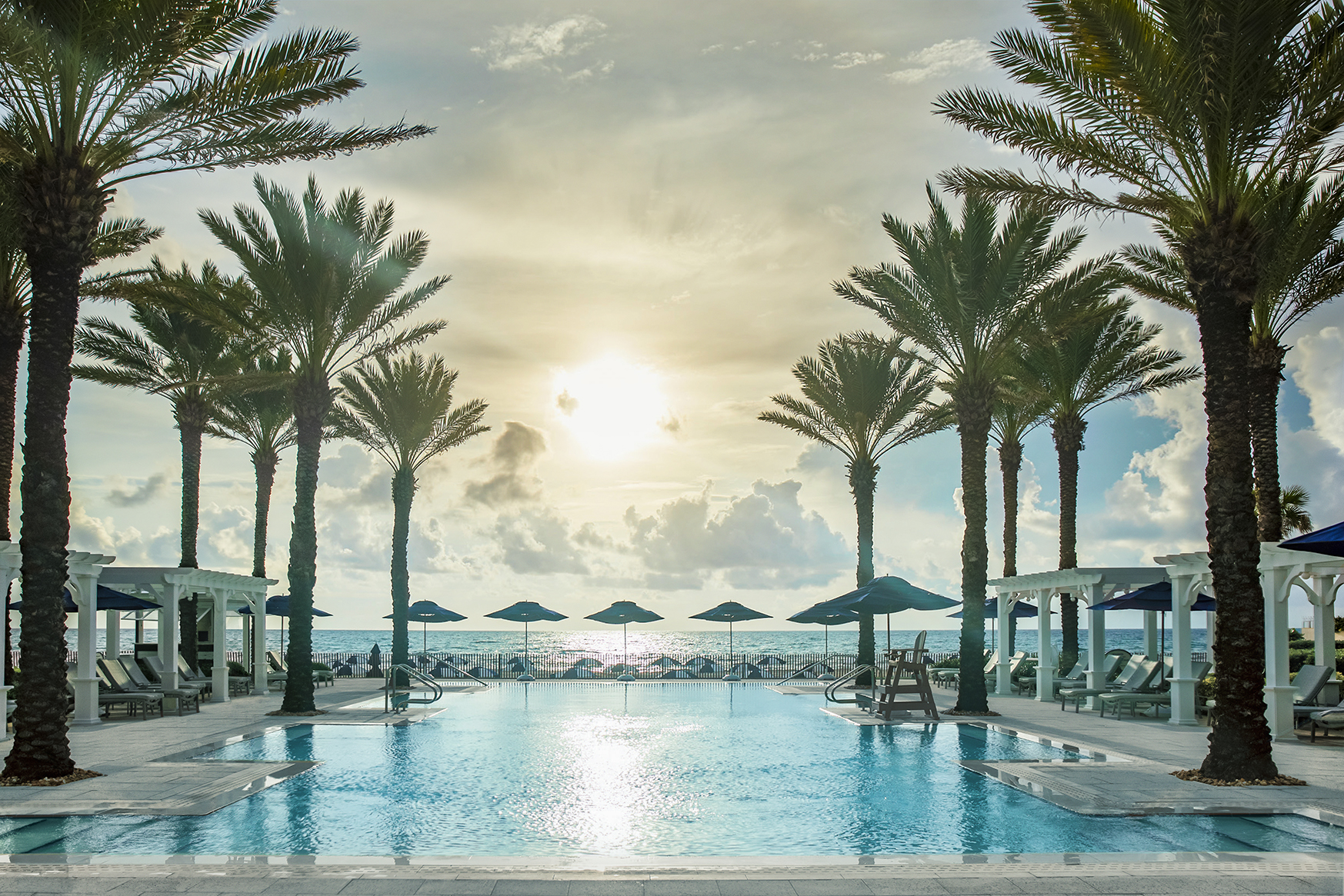 North America, USA & Canada, Florida, The Breakers, adult pool surrounded by palm trees and sun loungers with sea view
