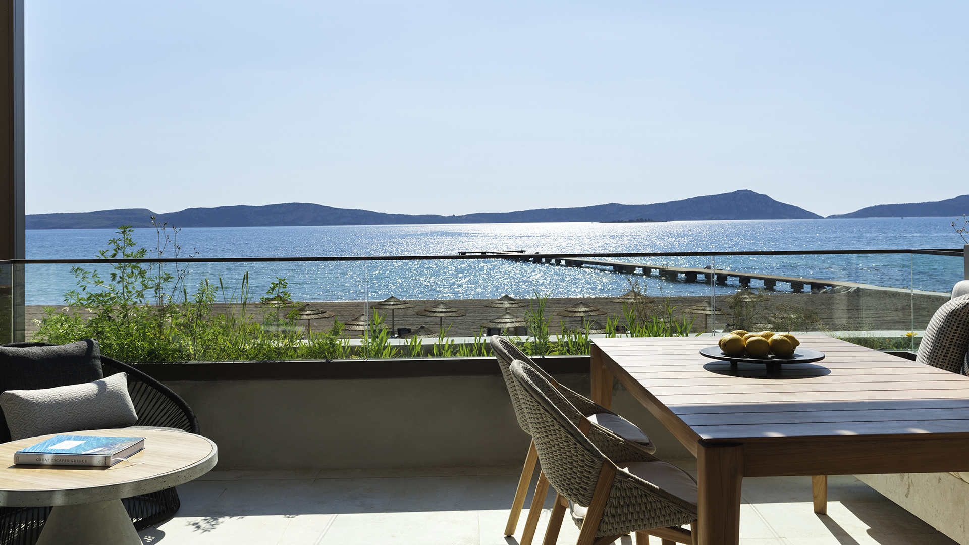 Tables on the terrace of a Bayfront Suite overlooking the beach at W Costa Navarino