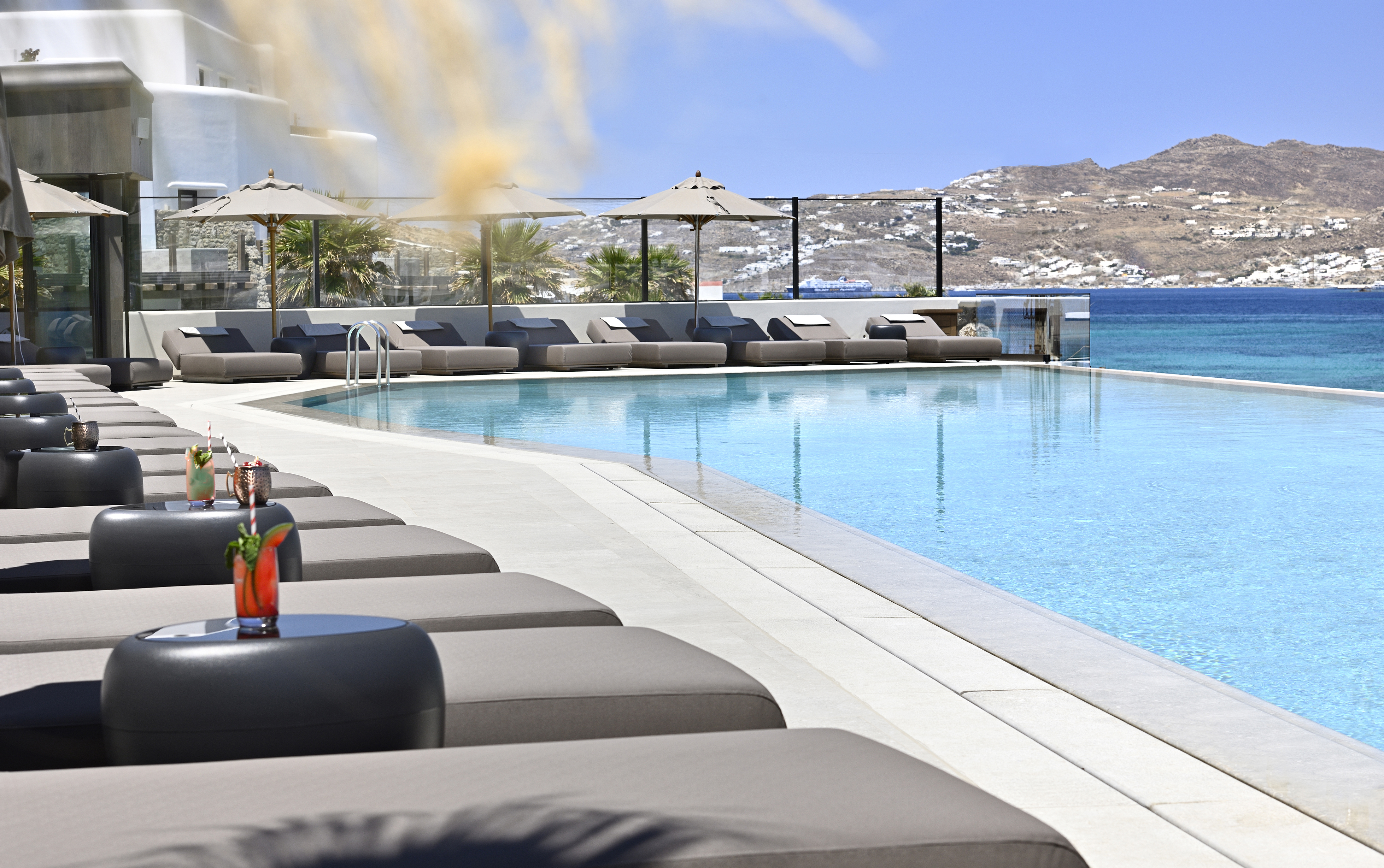 Rows of sun loungers by the main pool at Aeonic Suites & Spa