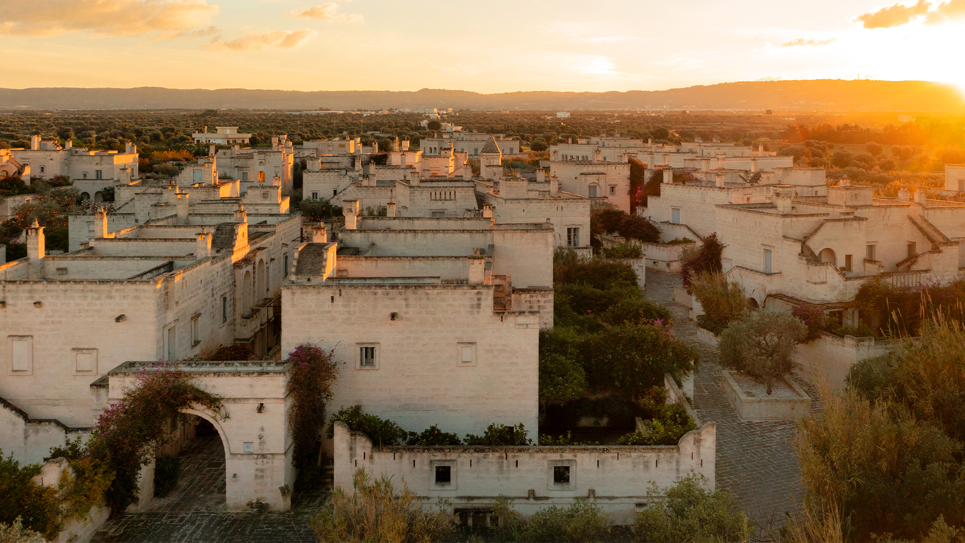 Sunset over the ancient white-washed buildings of a historic town.