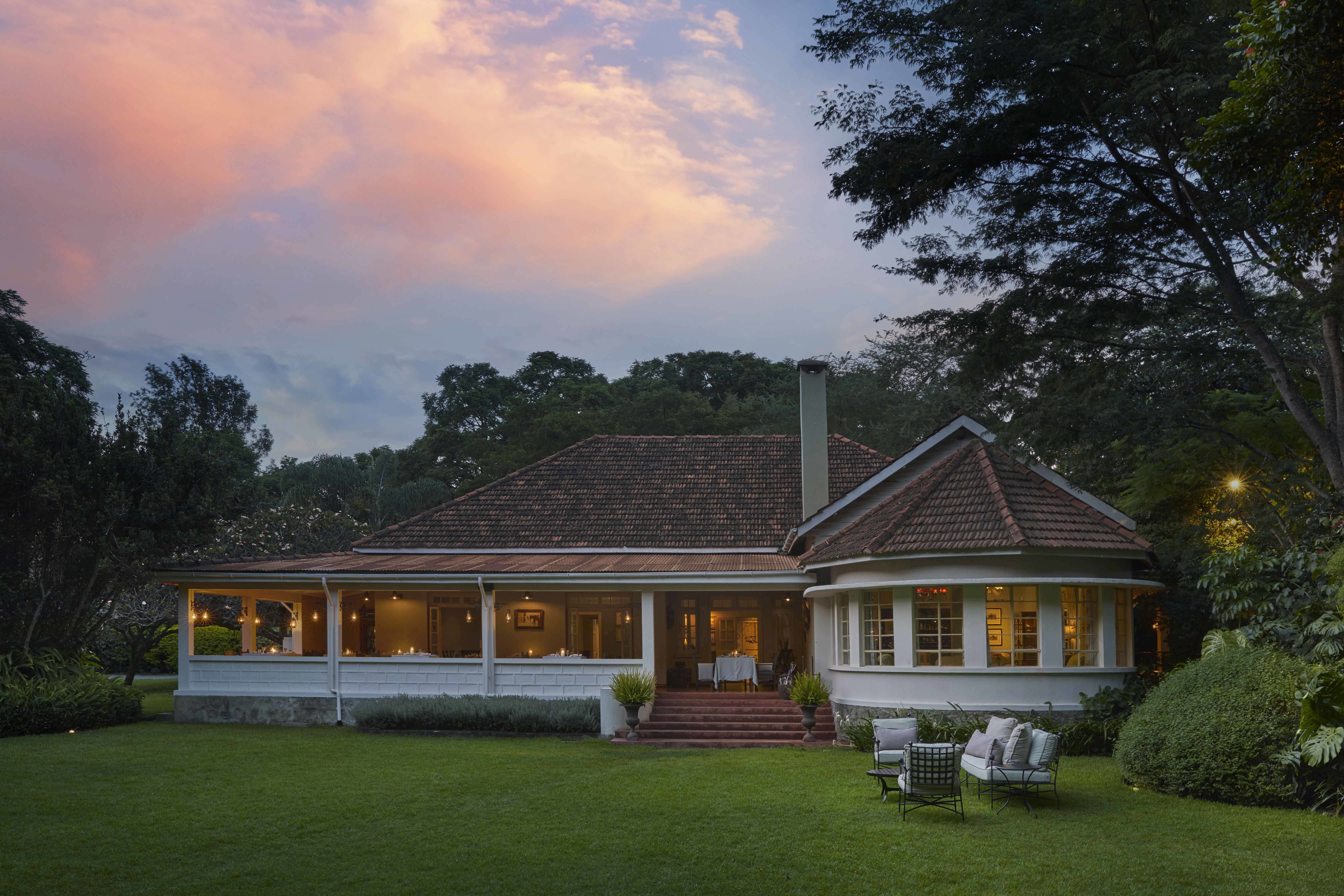 The white and red tile exterior of Lengendary Lodge in Arusha at dusk