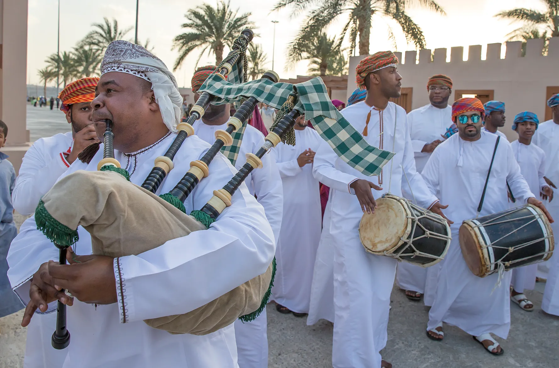 A group of Omani men playing the drums and bagpipes as part of a culture festival in Muscat