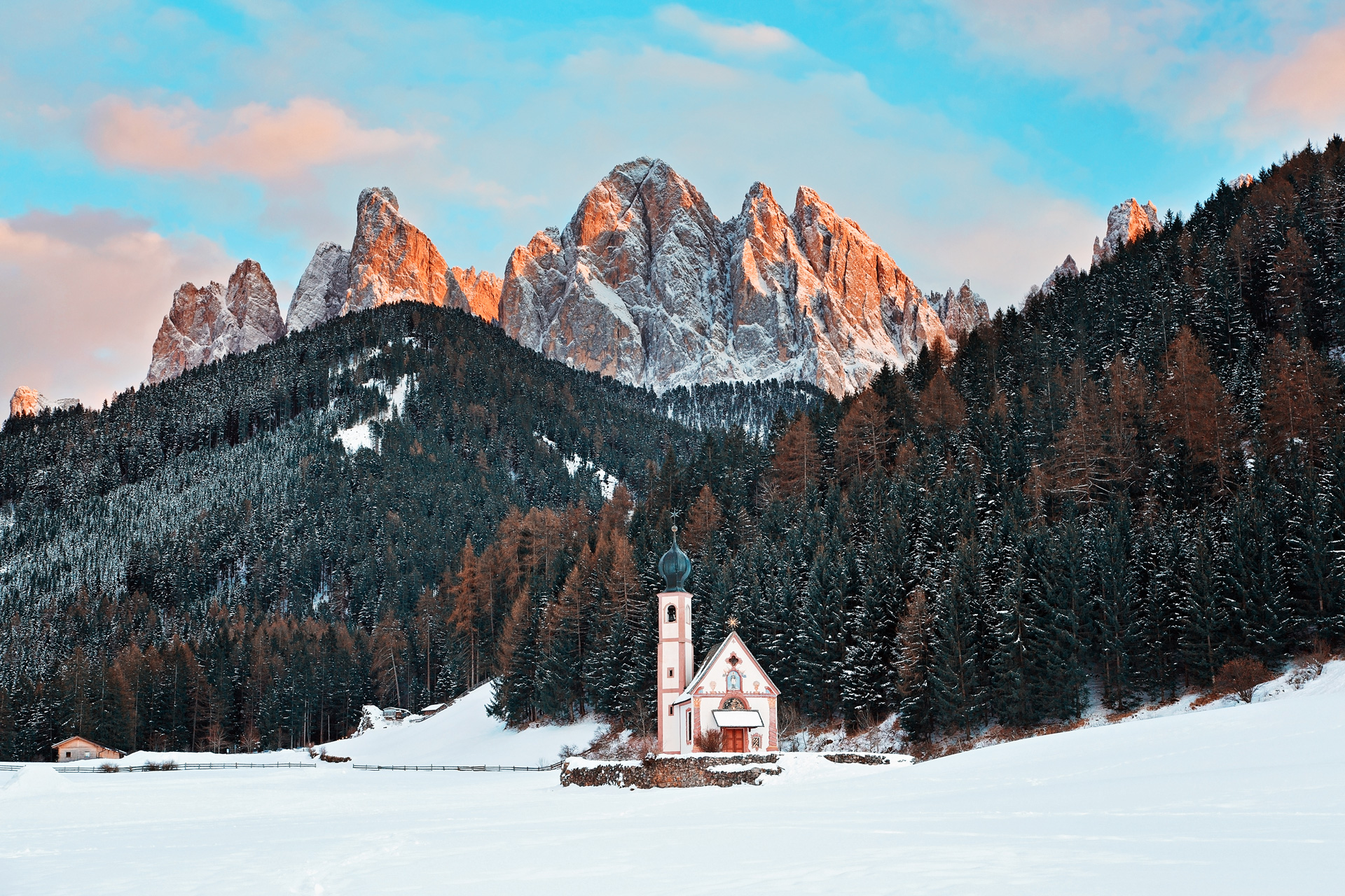 A standalone church below the rocky Odle peaks in the Villnöss Valley, Dolomites, Italy