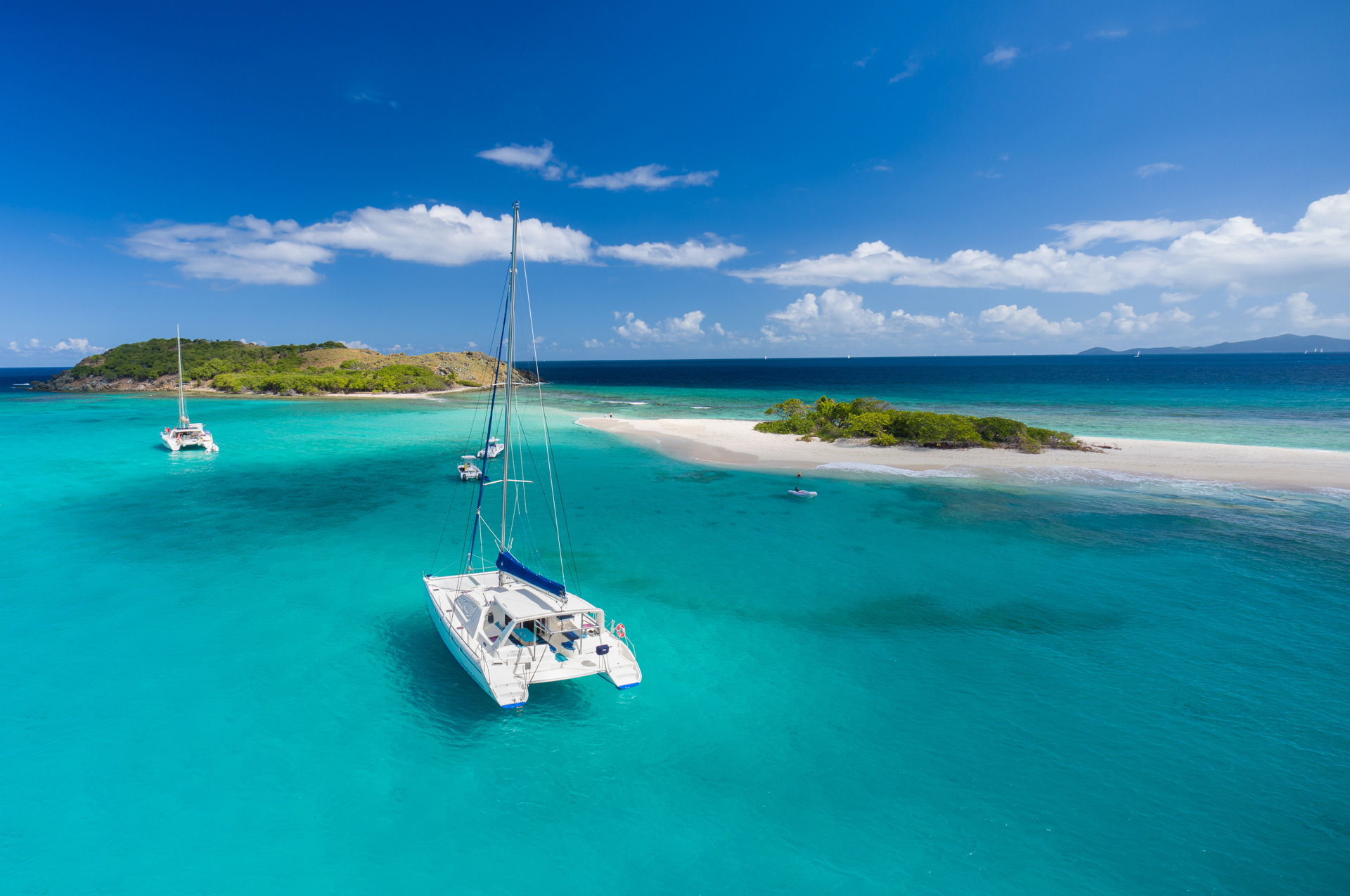Yachts in the sea nearby green islands