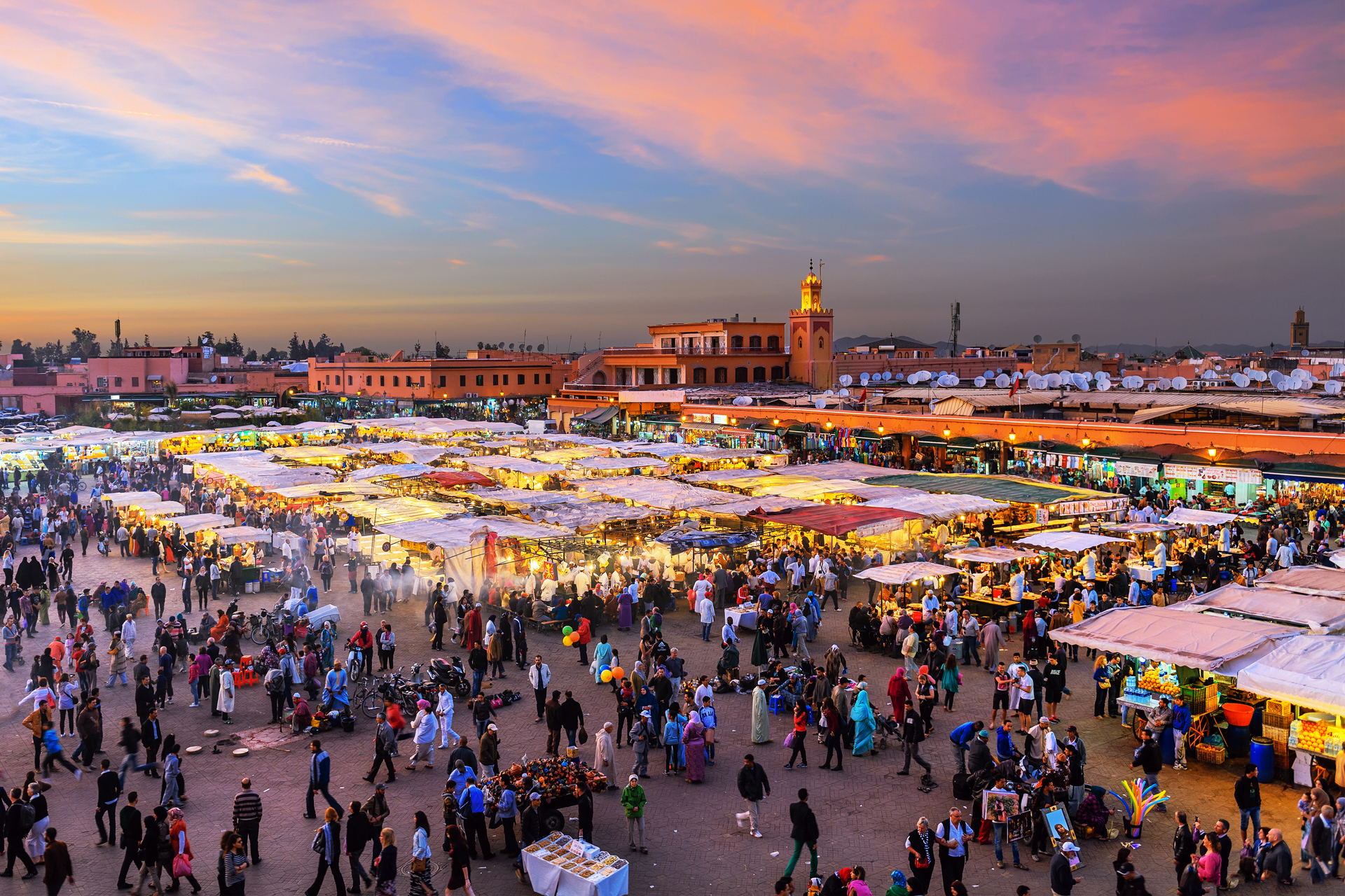 An aerial view of a busy market at sunset