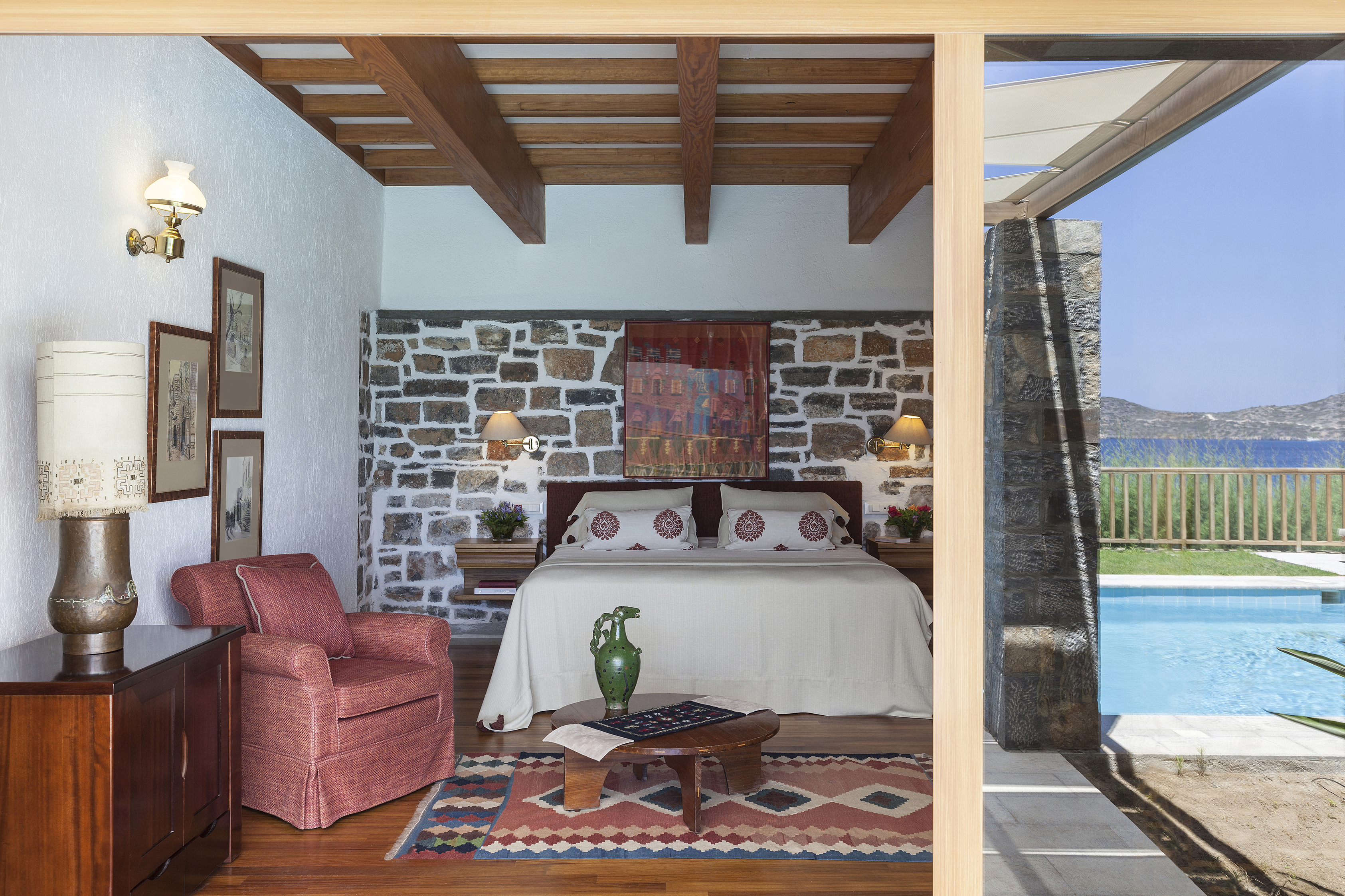 Beamed second Minoan bedroom with authentic Crete artofacts and red decor accents