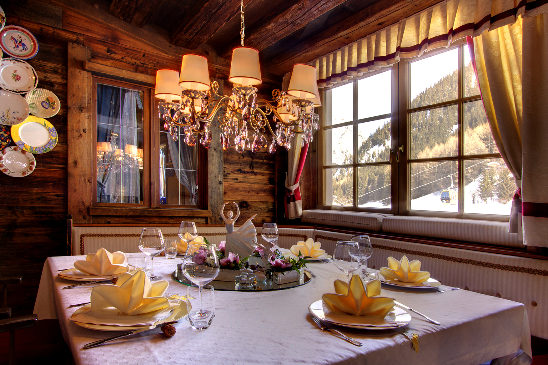 Italy ski holidays, The Dolomites, Hotel La Perla, dining table set for four with napkins folded like lilypads and a ballerina figurine centerpiece