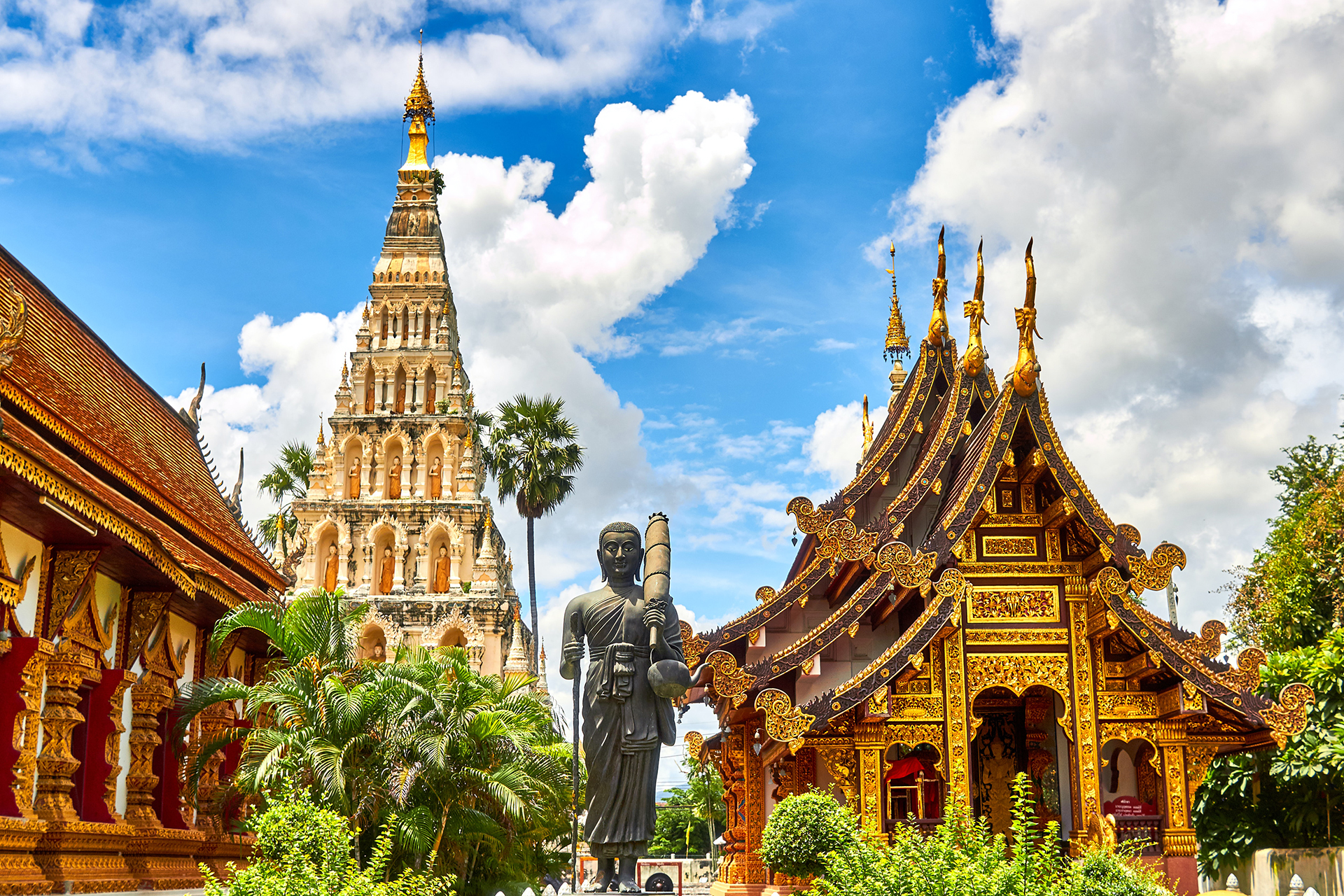 Standing statue and golden temples in Thailand