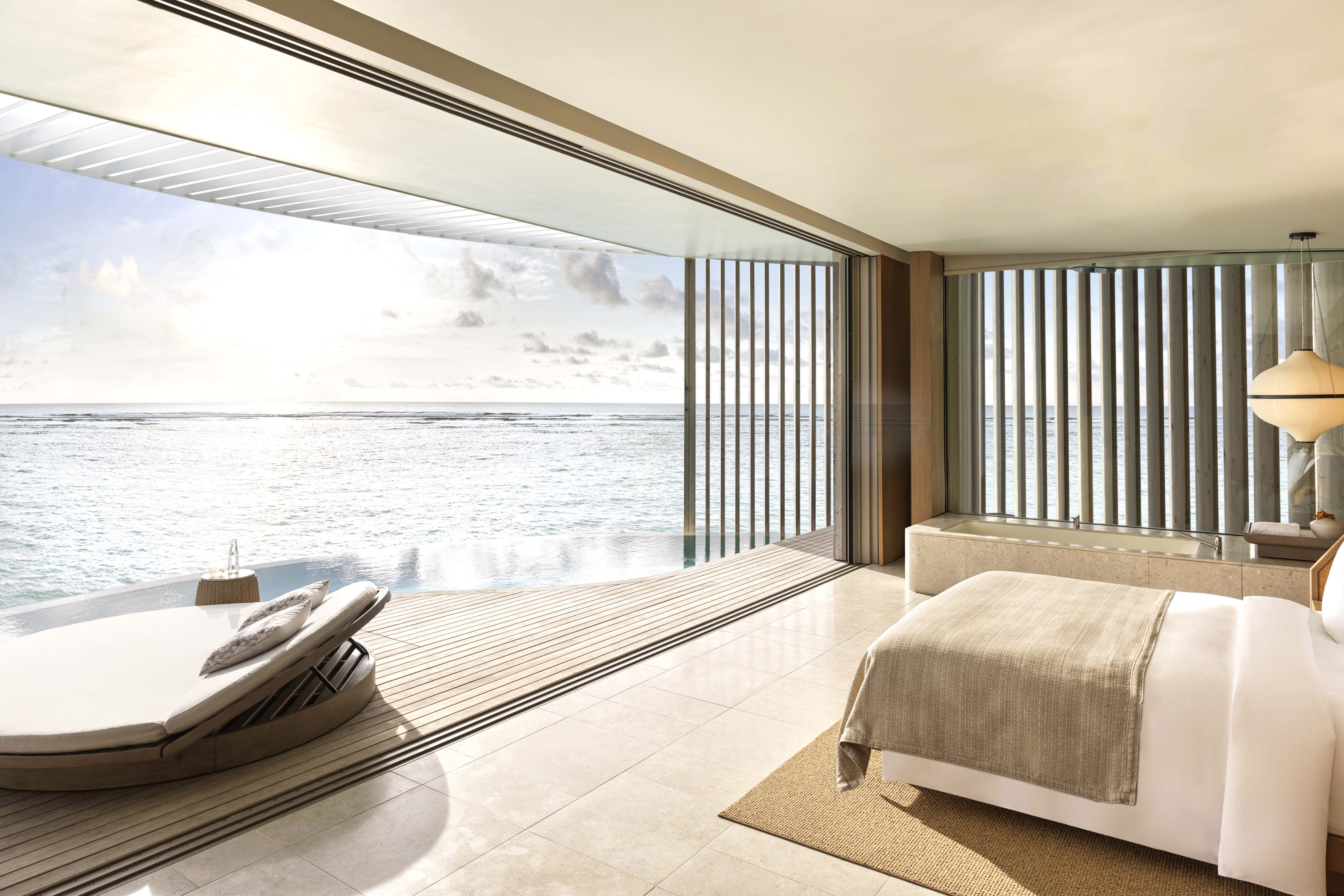 Bedroom and private pool of lagoon villa decorated in neutral shades