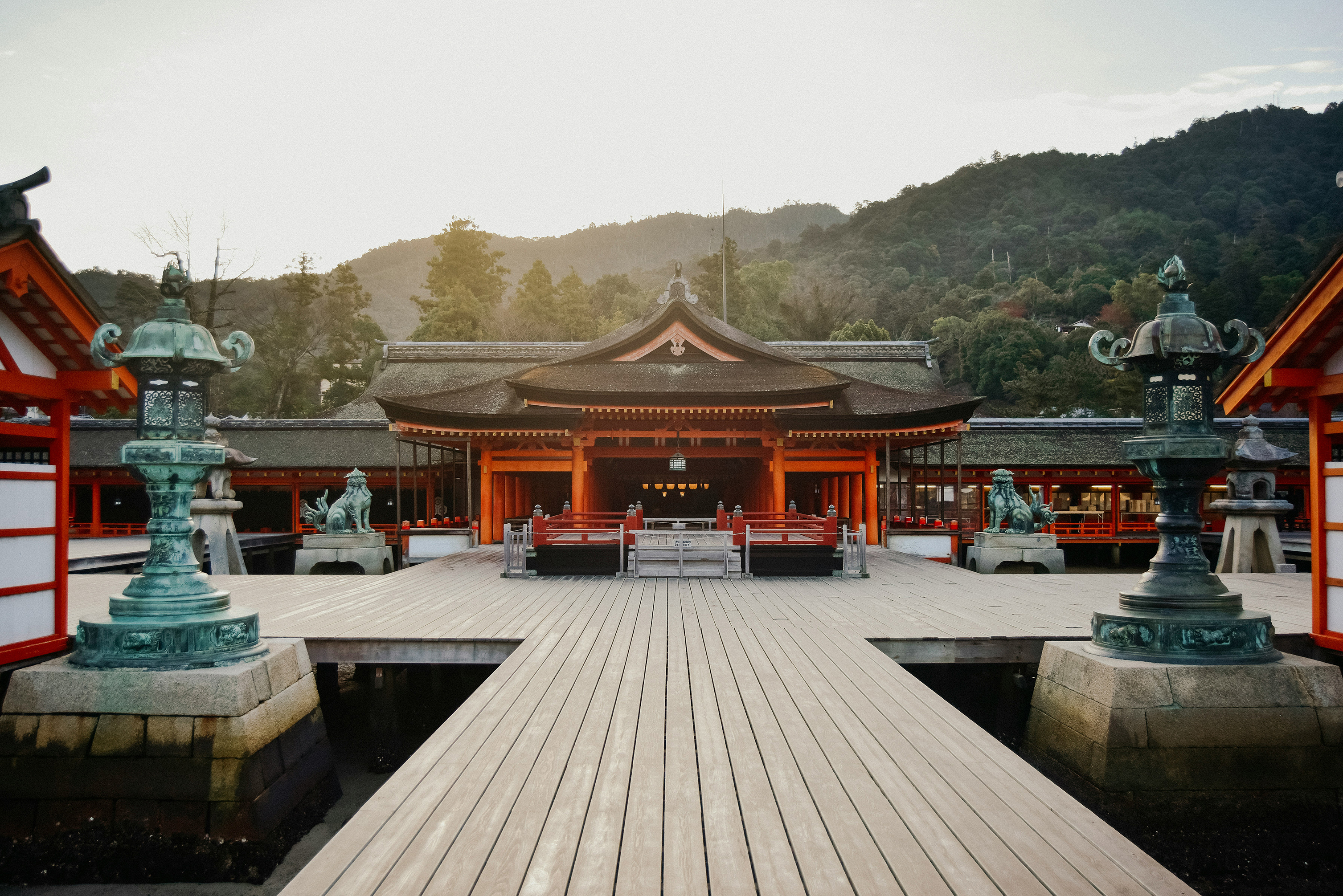 The Itsukushima Jinja in Hiroshima complete with ornate lanterns, lion statues and traditional Japanese red and black architecture