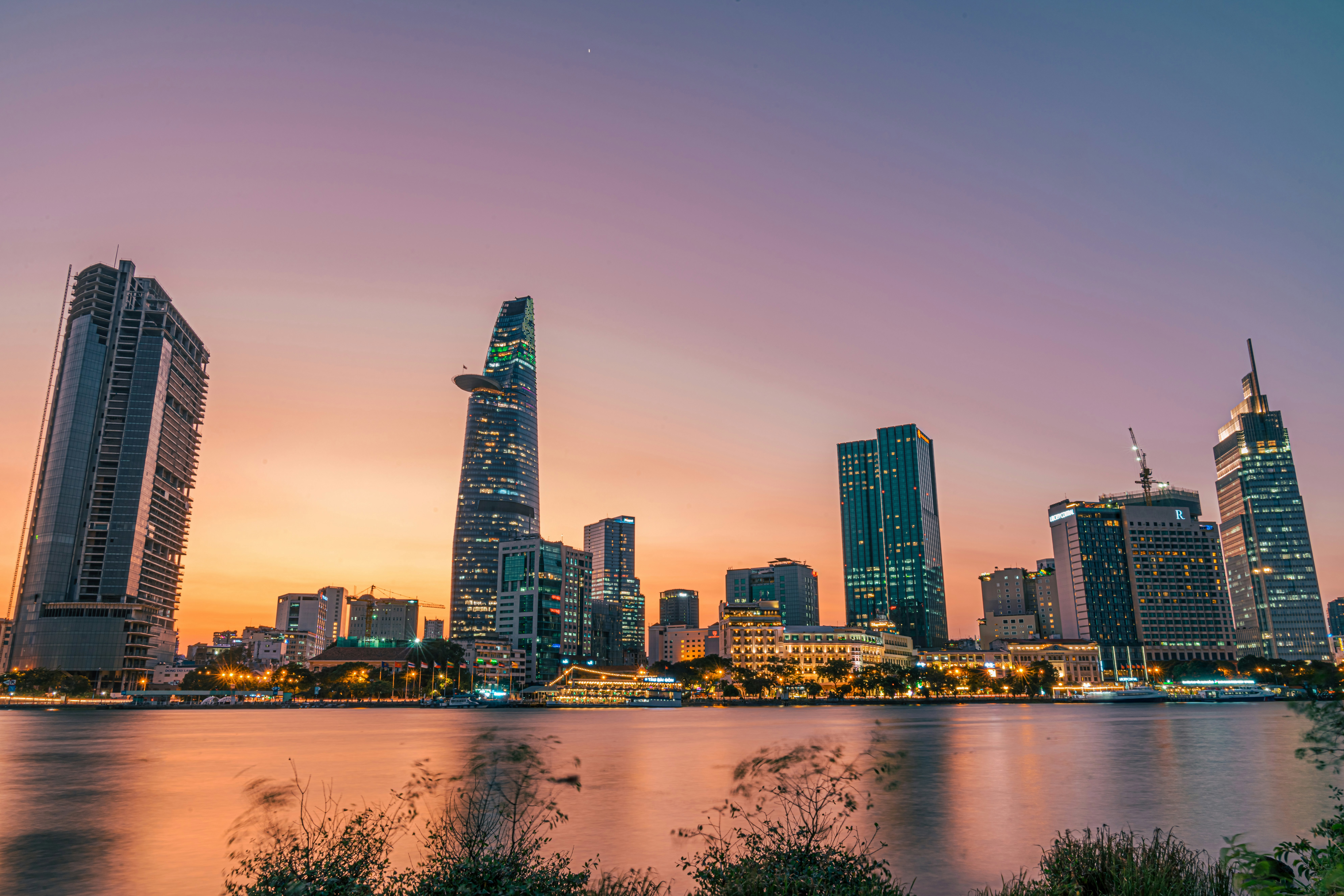 Skyscrapers along the riverbank at sunset in Ho Chi Minh city