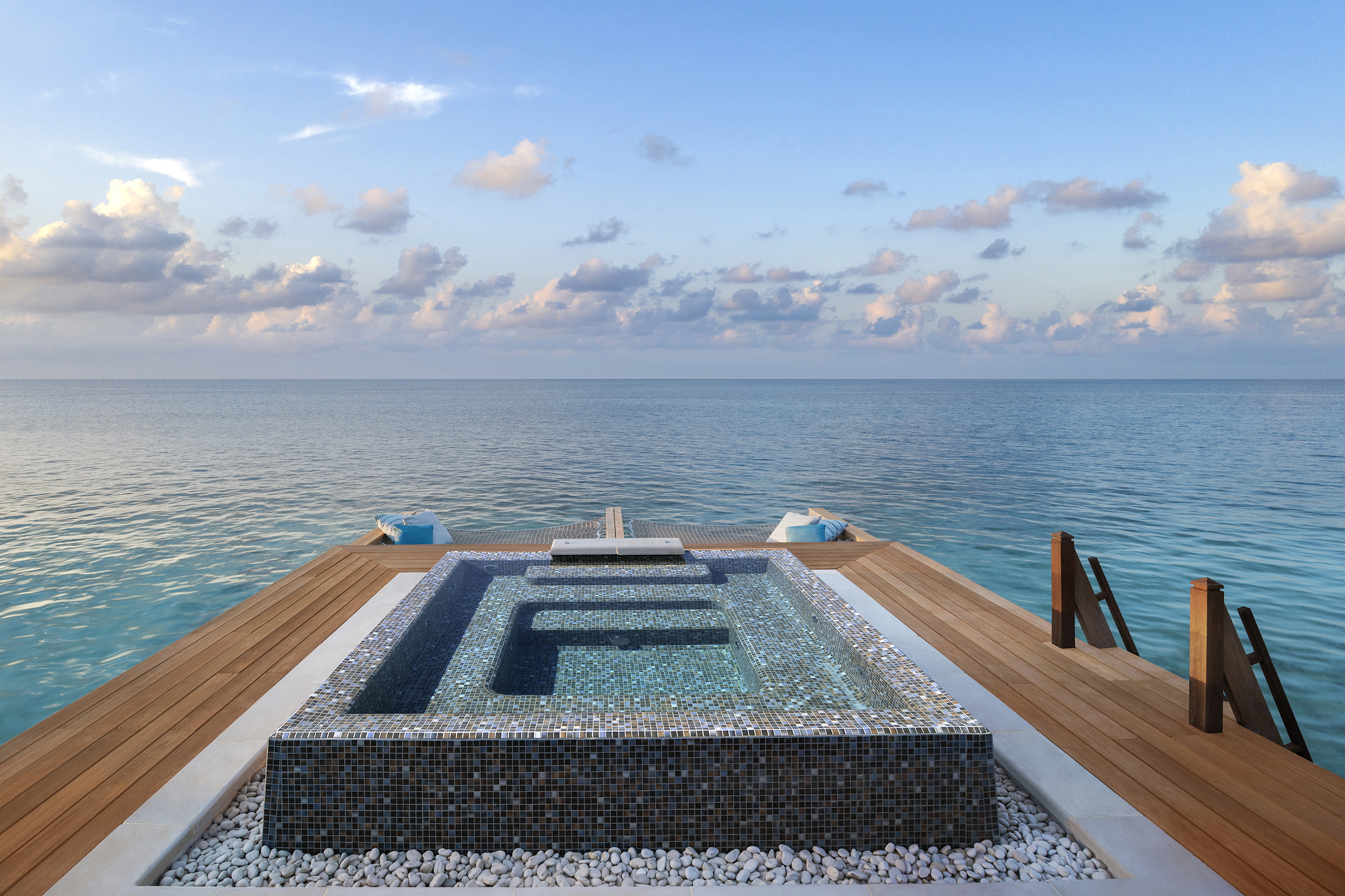 Blue mosaic Jacuzzi on wooden overwater terrace of Three Bedroom Overwater Villa