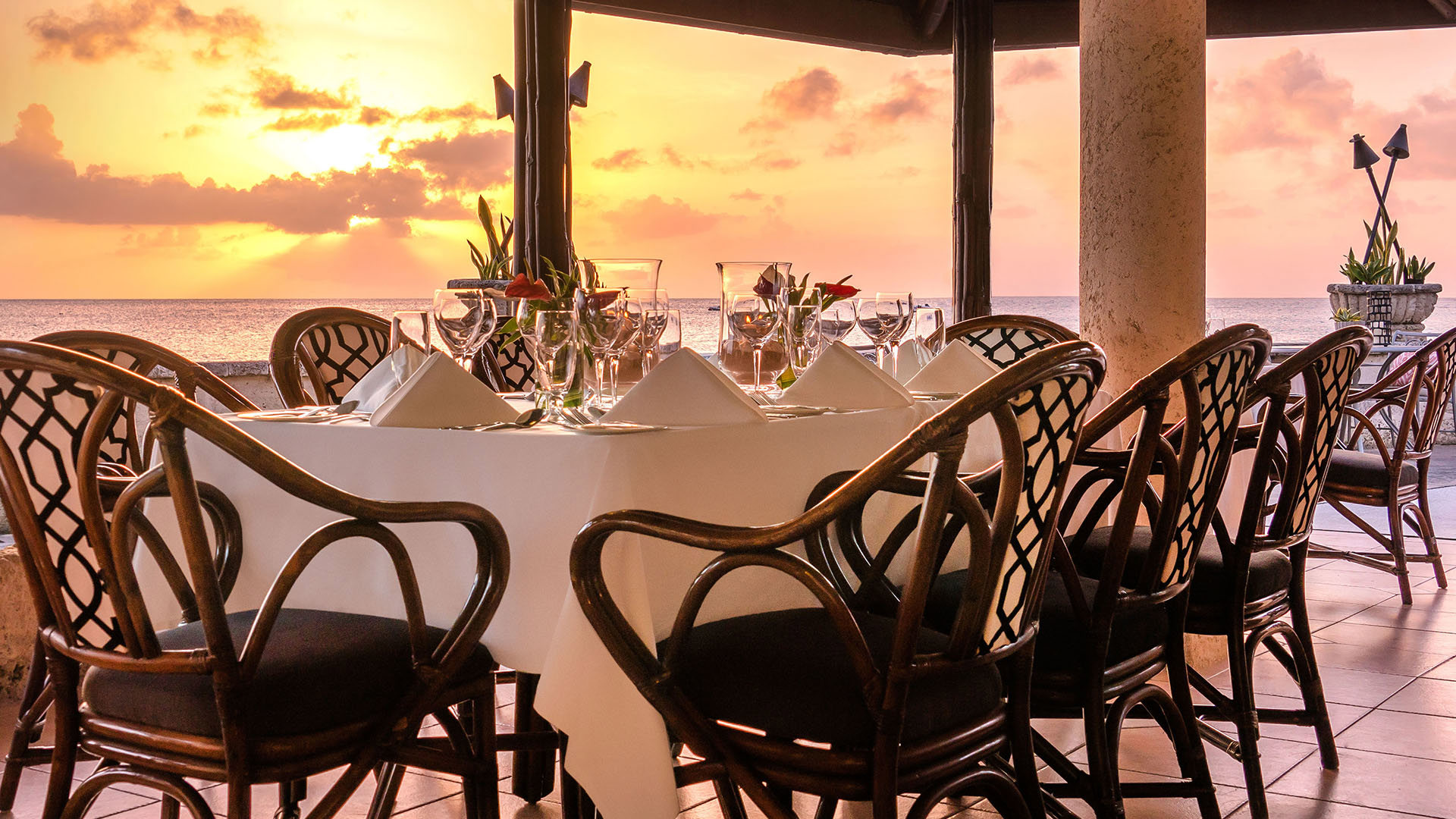 Table set for dinner at sunset on the terrace of Coral Reef Club