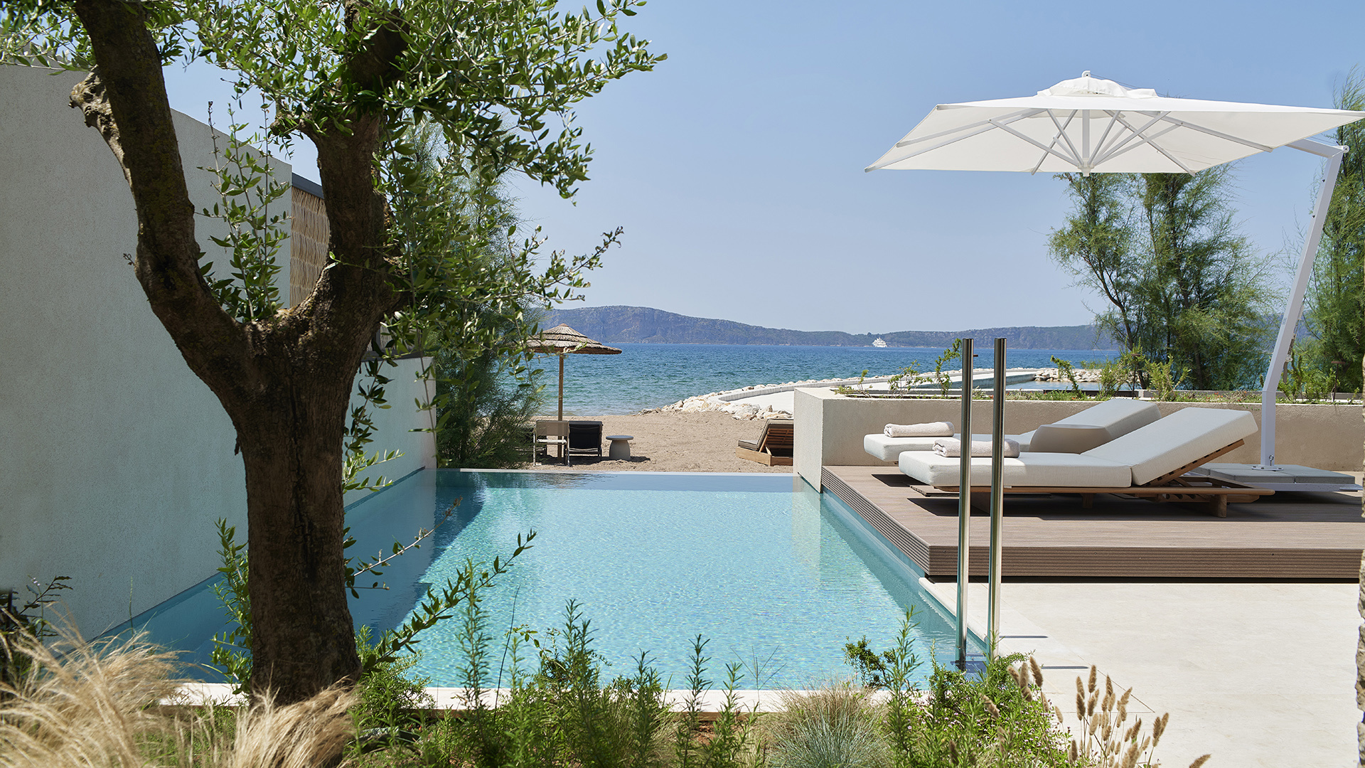 Pool leading to beach in a Beachfront Suite at W Costa Navarino