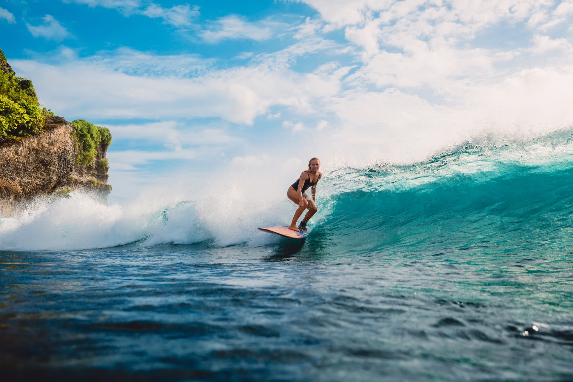 A woman surfing a wave