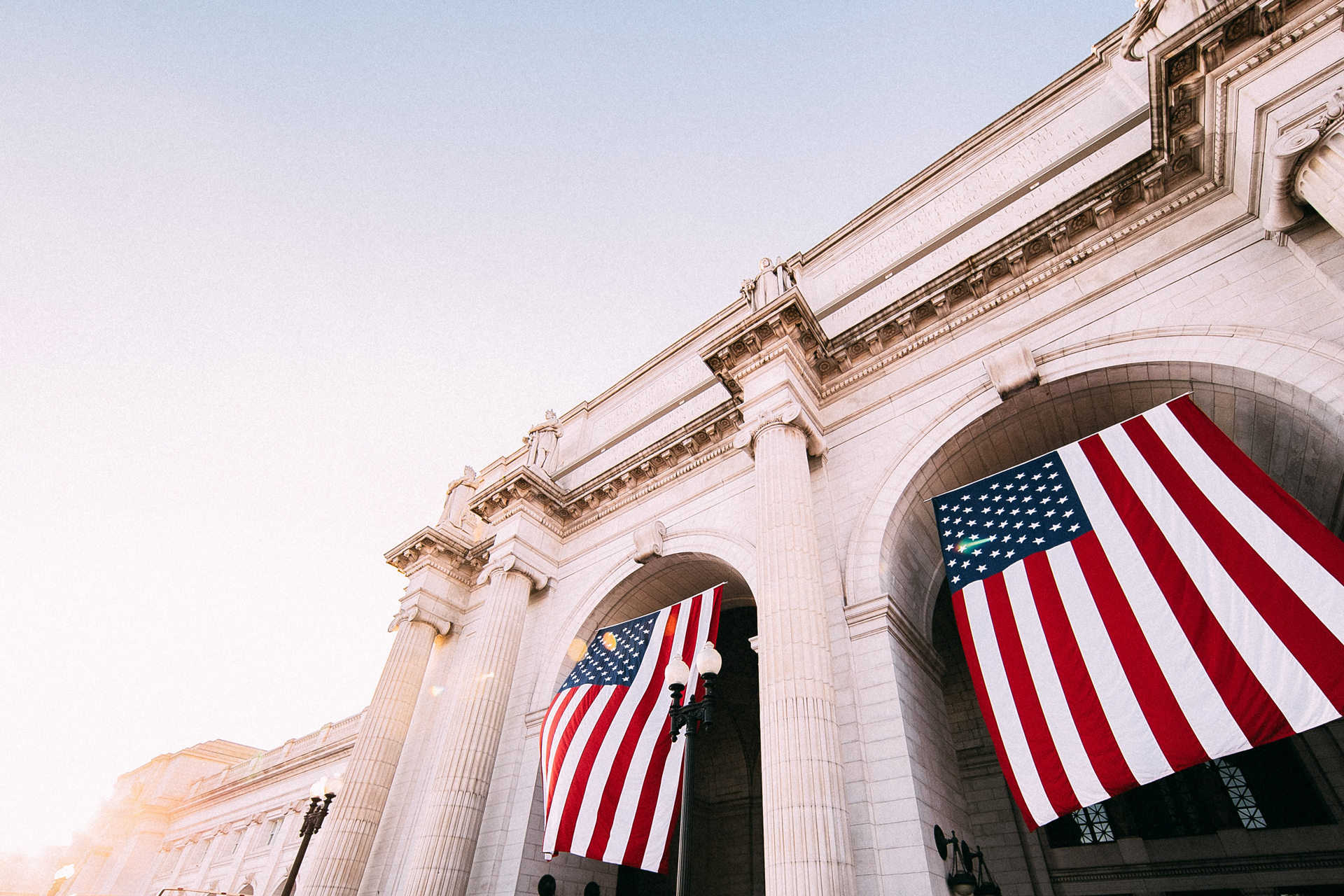 USA flag hanging on the stone union station building