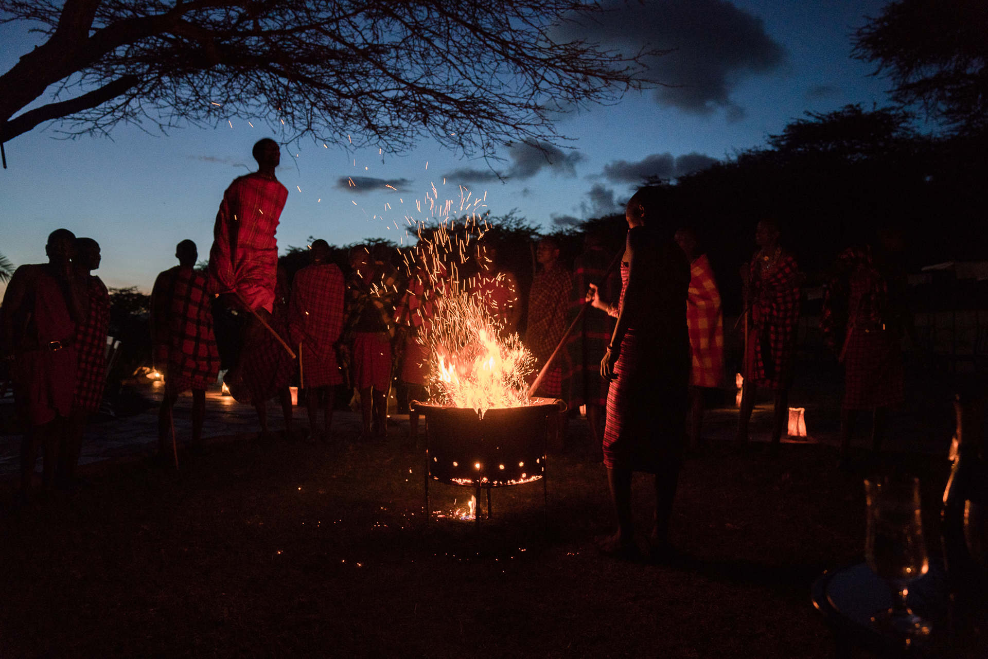 People stood around a campfire at Cottars Camp 1920