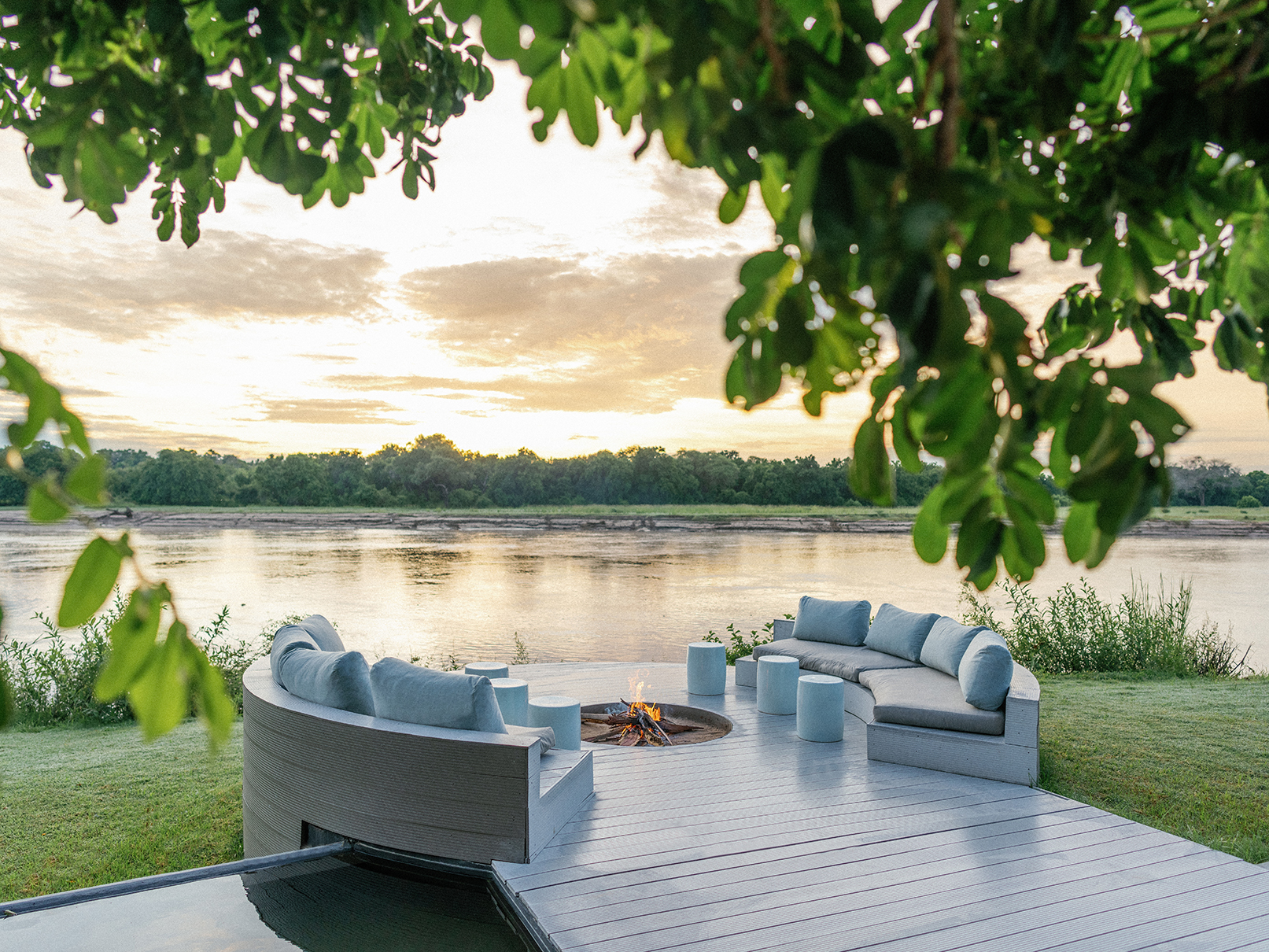Africa, Zambia, Time + Tide Chinzombo, firepit and seating by the riverfront