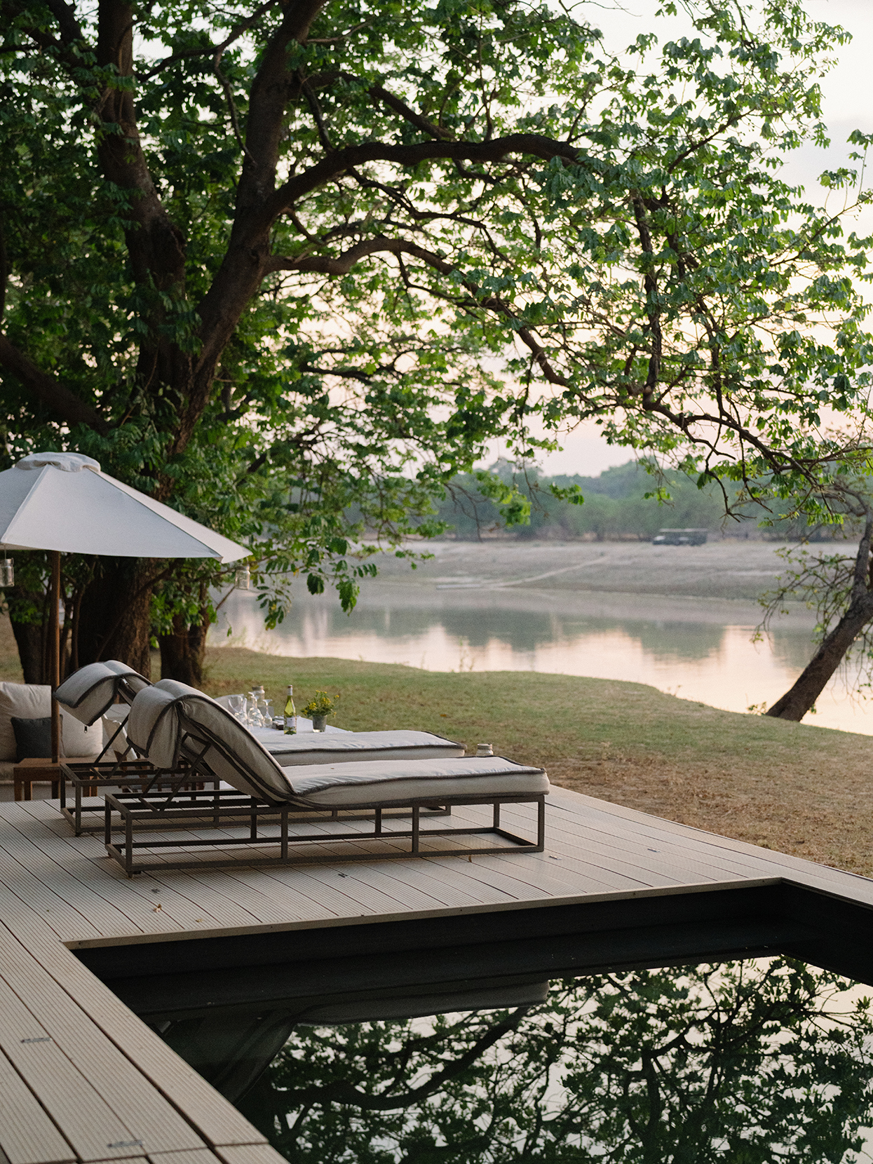 Africa, Zambia, Time + Tide Chinzombo, poolside sunloungers by the riverfront