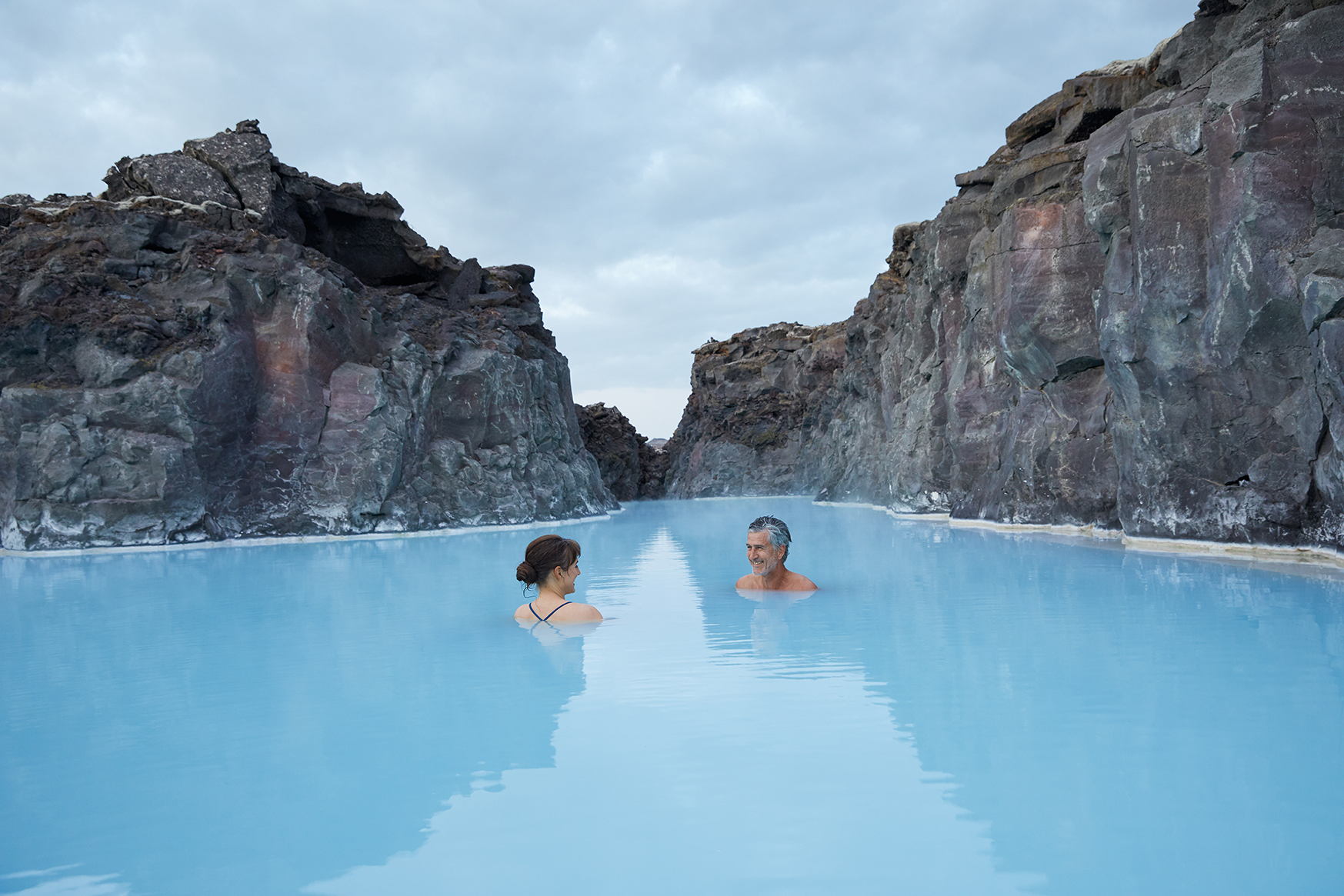 Europe, Iceland, The Retreat at the Blue Lagoon, two people in the blue lagoon