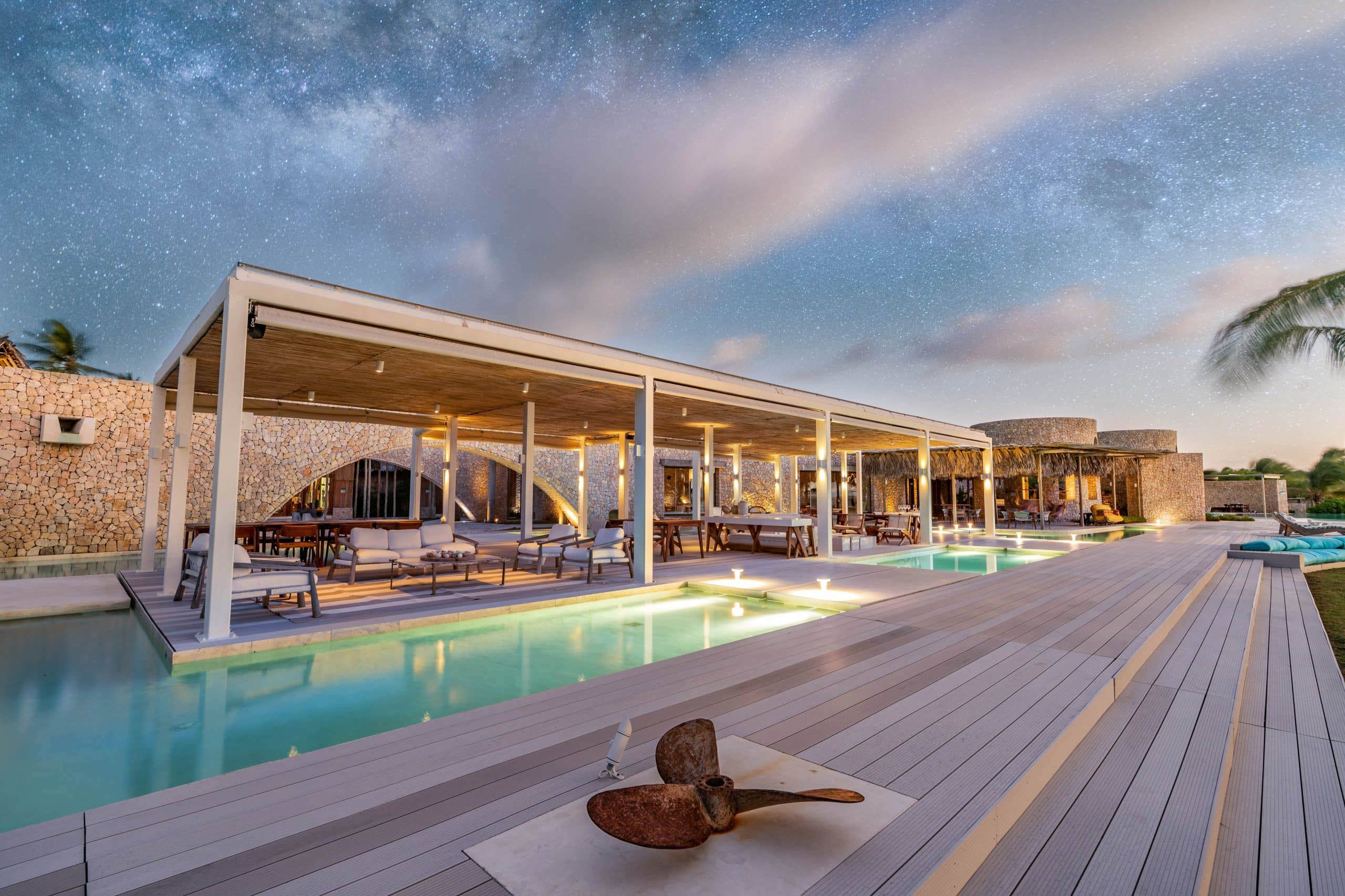 Miavana piazza restaurant and water lit up for sunset