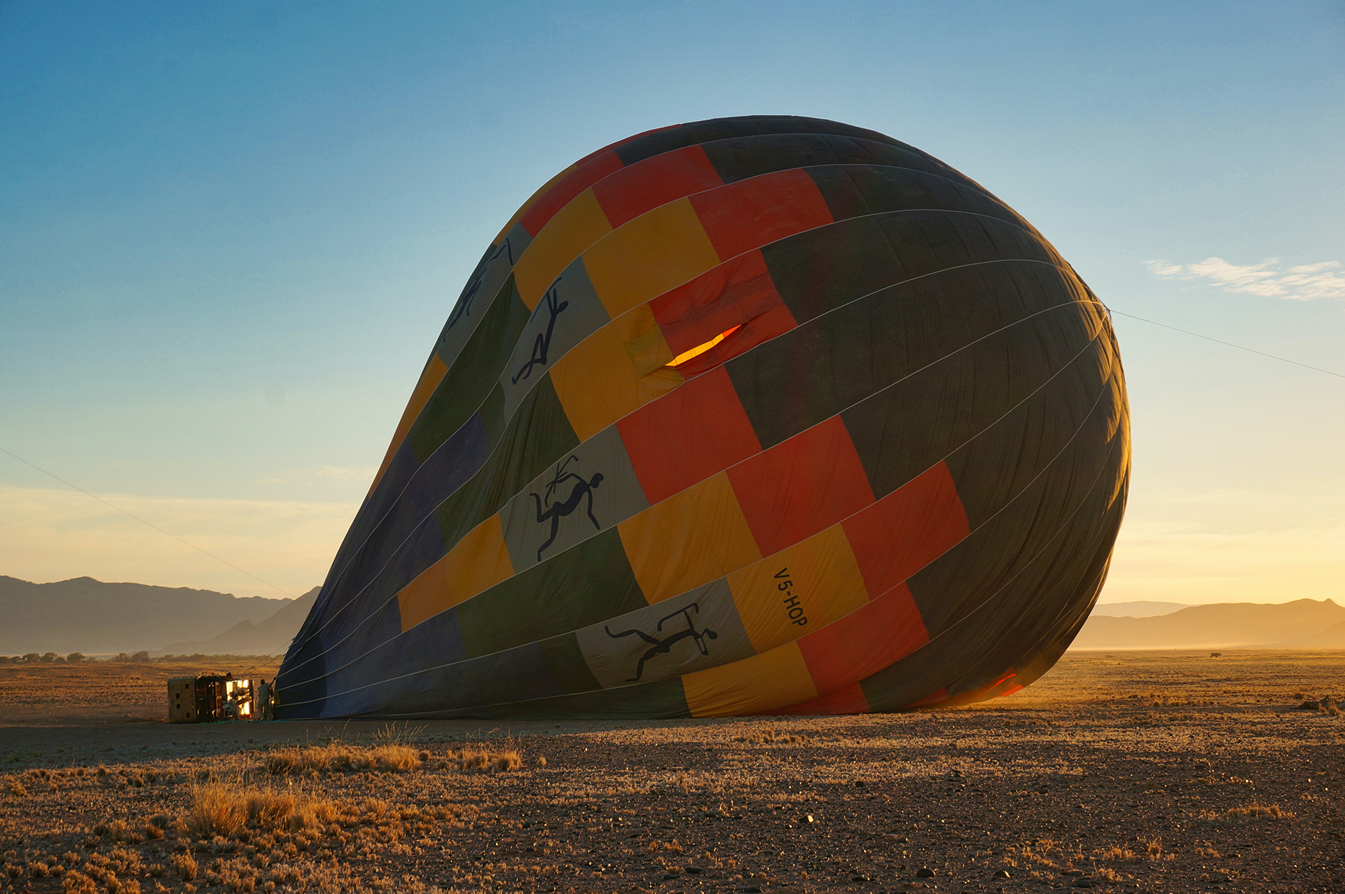 Red and blue hot air balloon on brown field