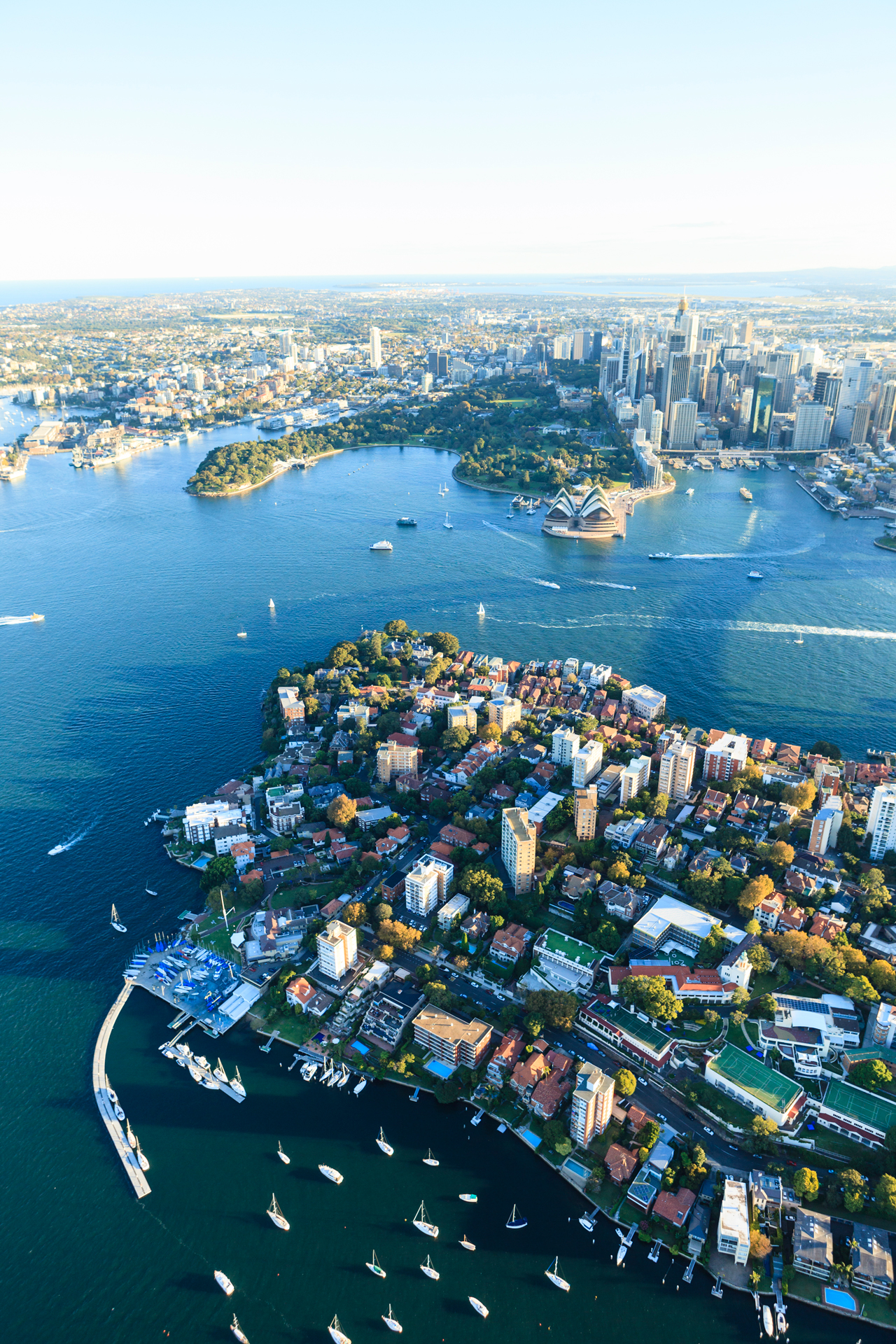 An aerial view of Sydney with the Opera House in the background