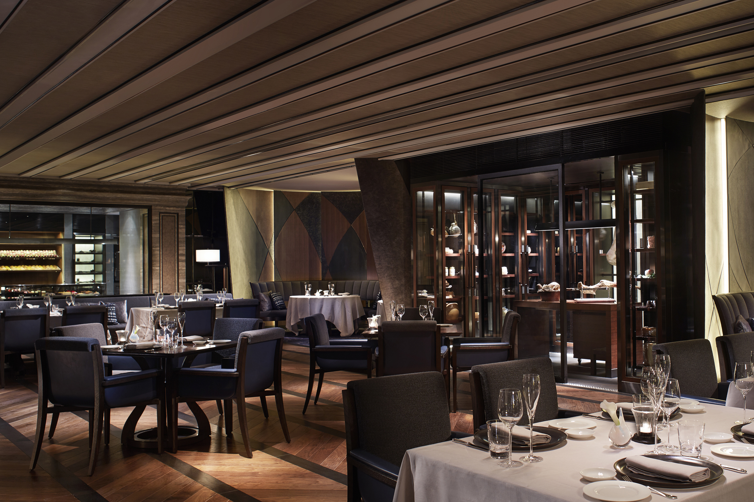 A sleek restaurant with luxurious dining tables set for dinner