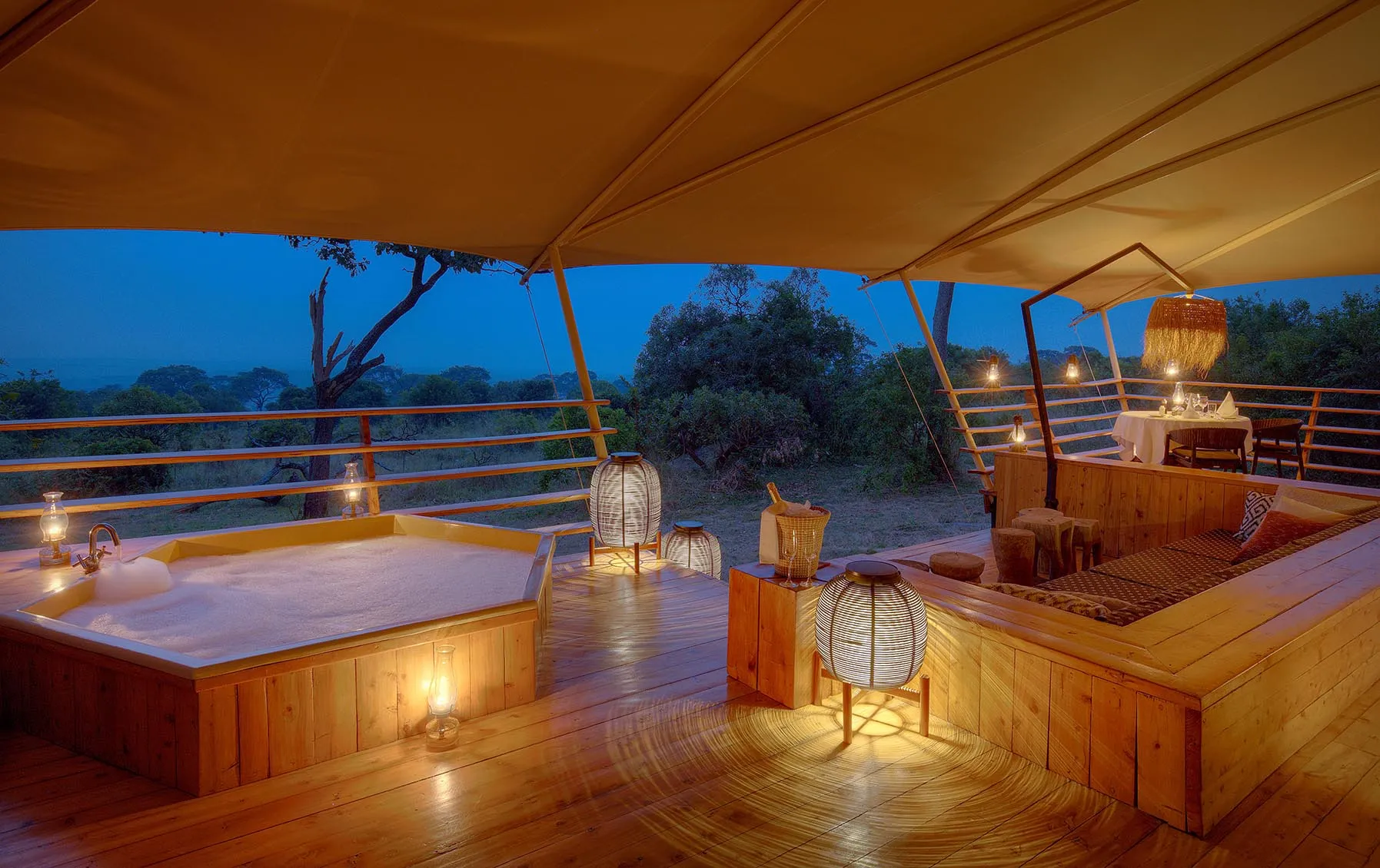 Africa, Tanzania, Serengeti Bushtops, bath and sofa in luxury tent at dusk