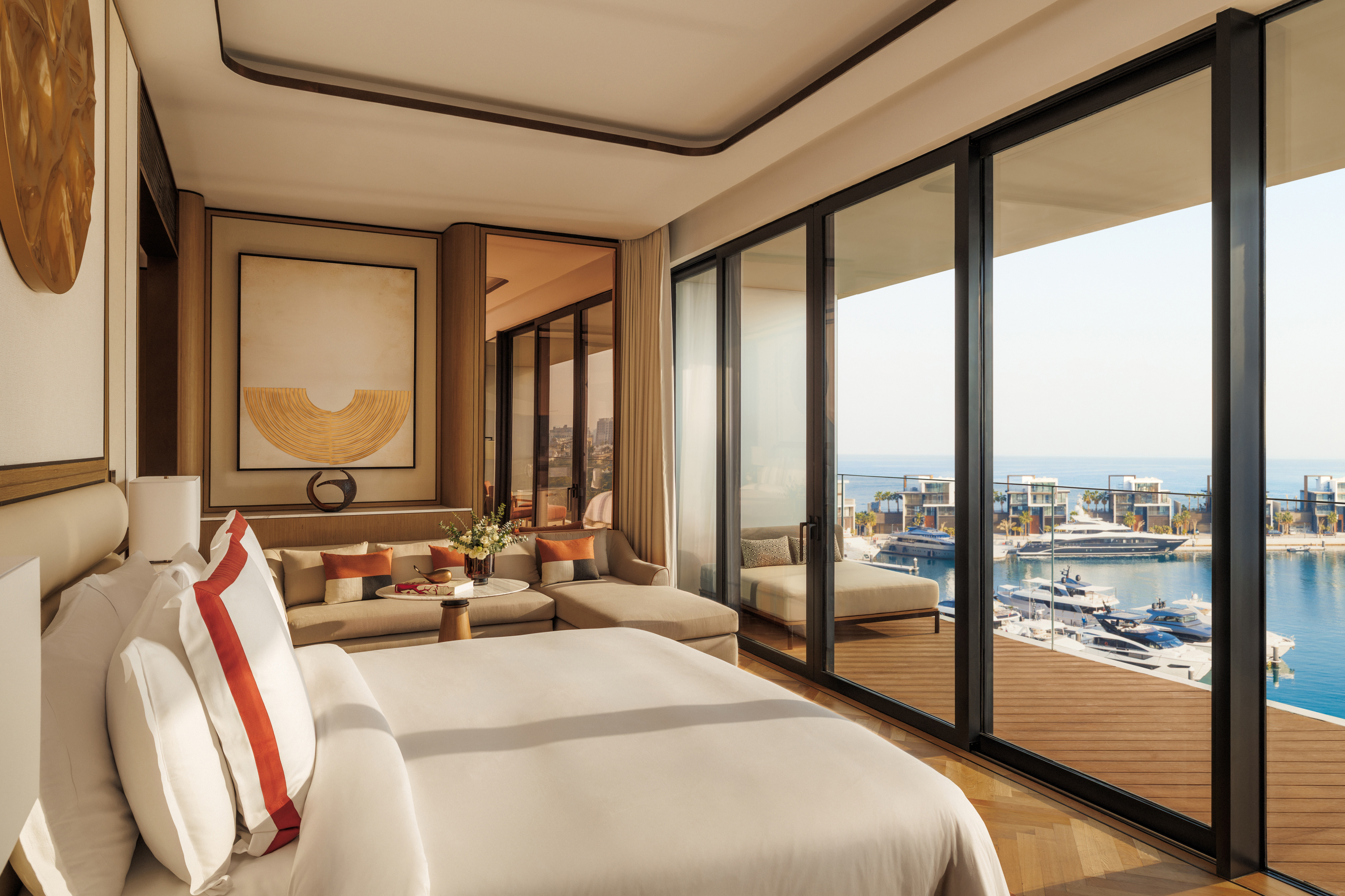 A lavish and airy room with marina view at Jumeriah Marsa Al Arab with warm neutral decor and a bed facing floor to ceiling windows