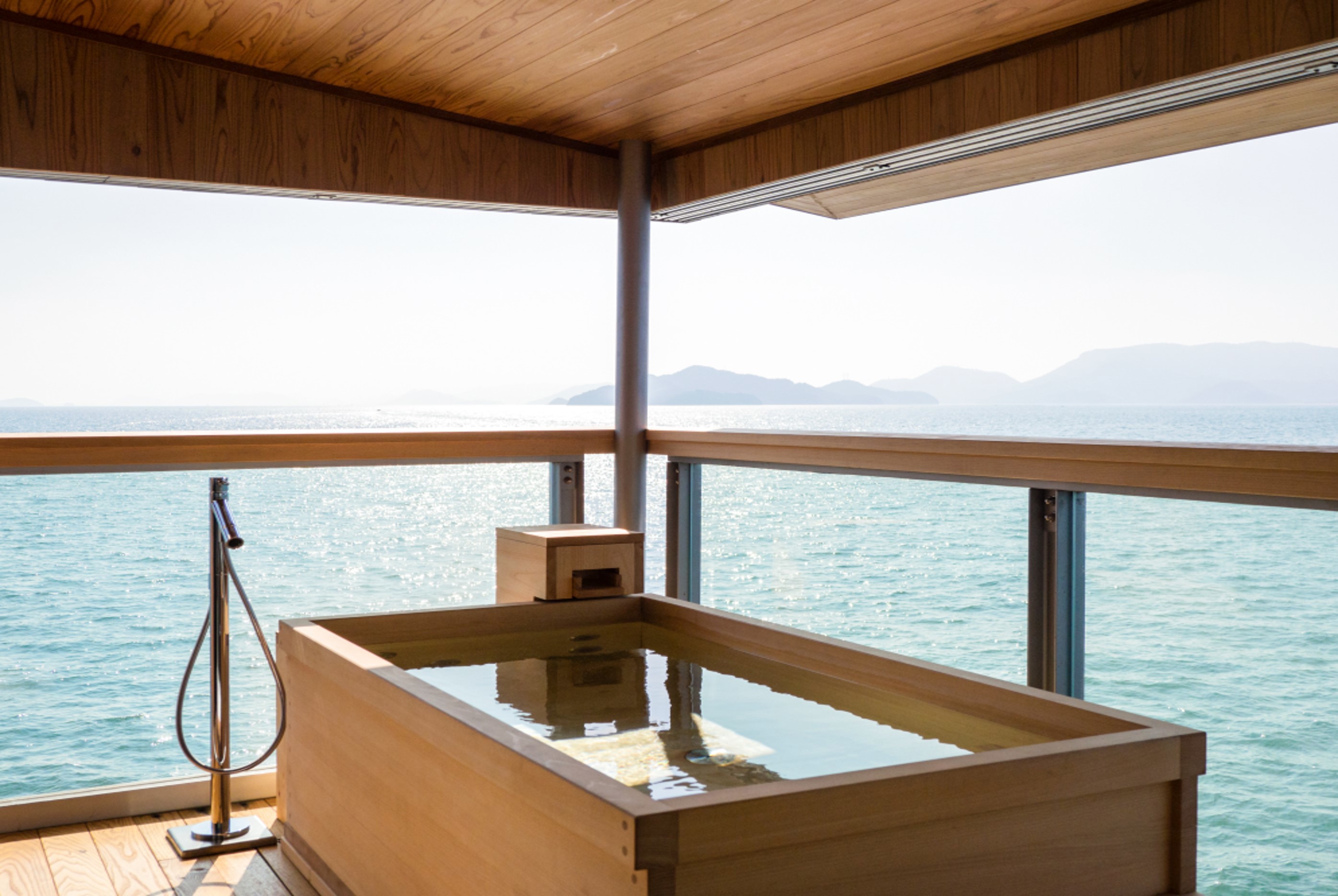 A [rivate wooden bath on the partially open-air terrace of a suite aboard Guntu