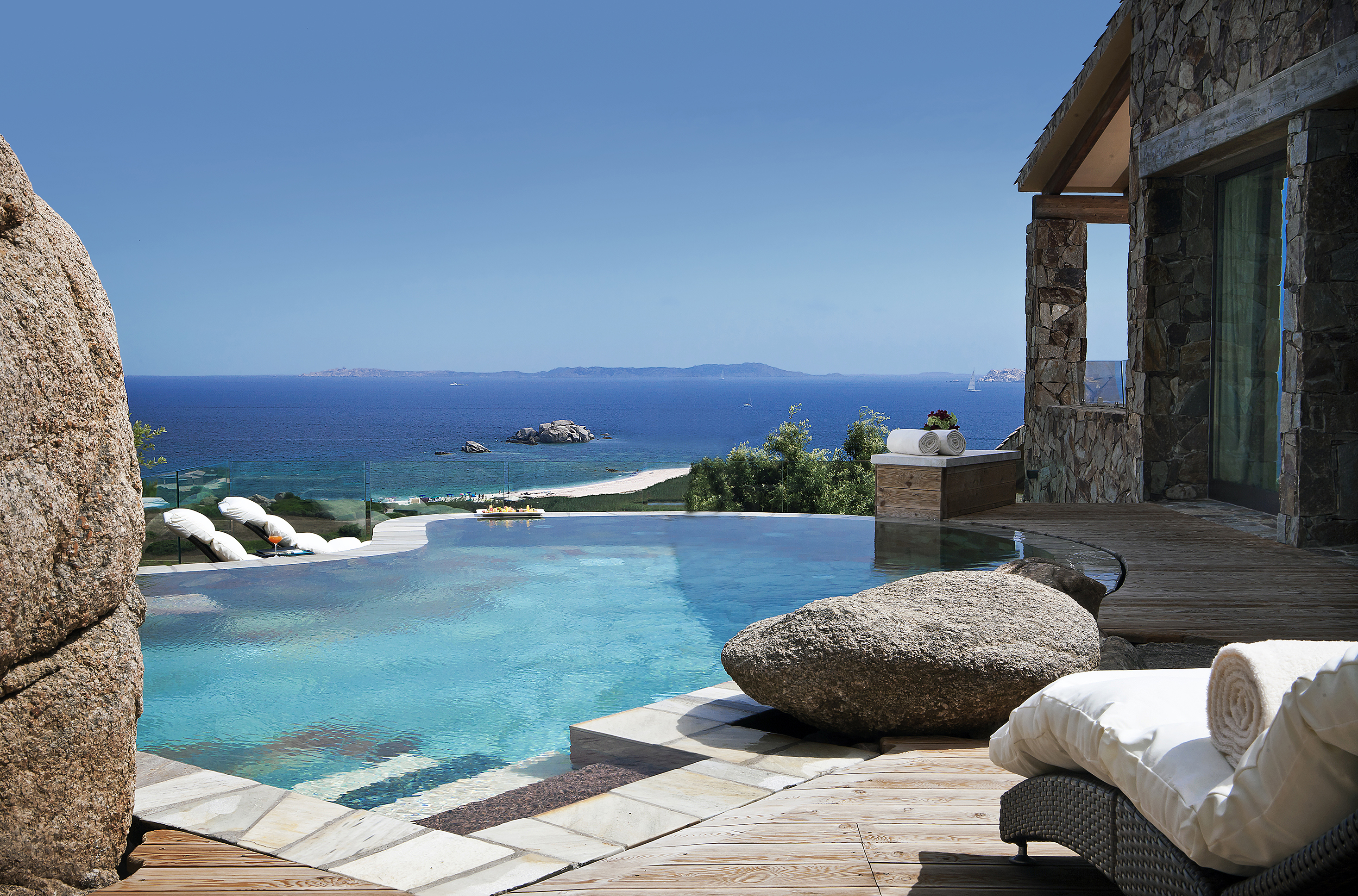 The private pool of a lavish suite made from stone with sweeping views of the ocean 