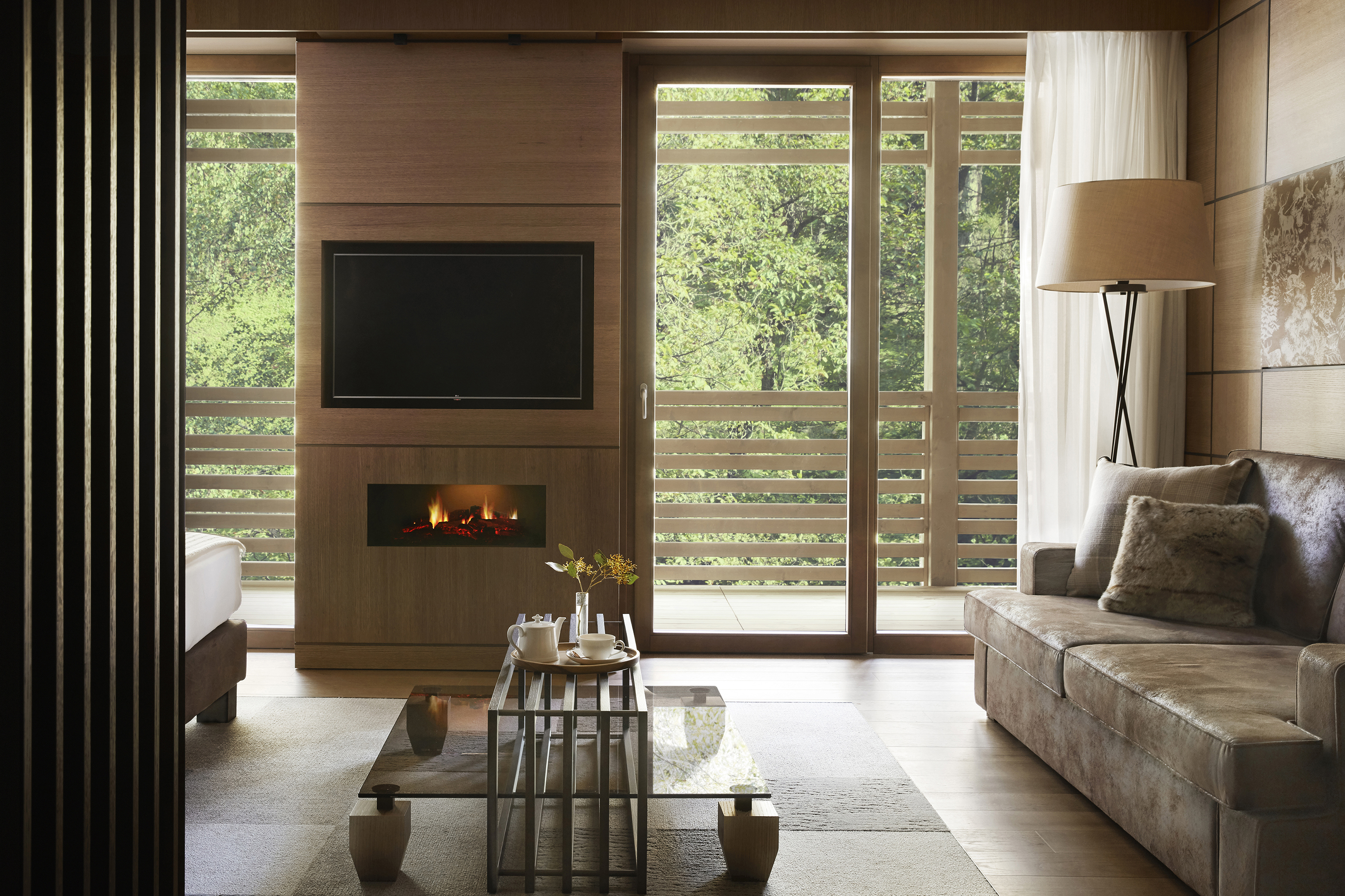 Prestige junior suite lounge with flat screen tv and scandi coffee table in front of sofa