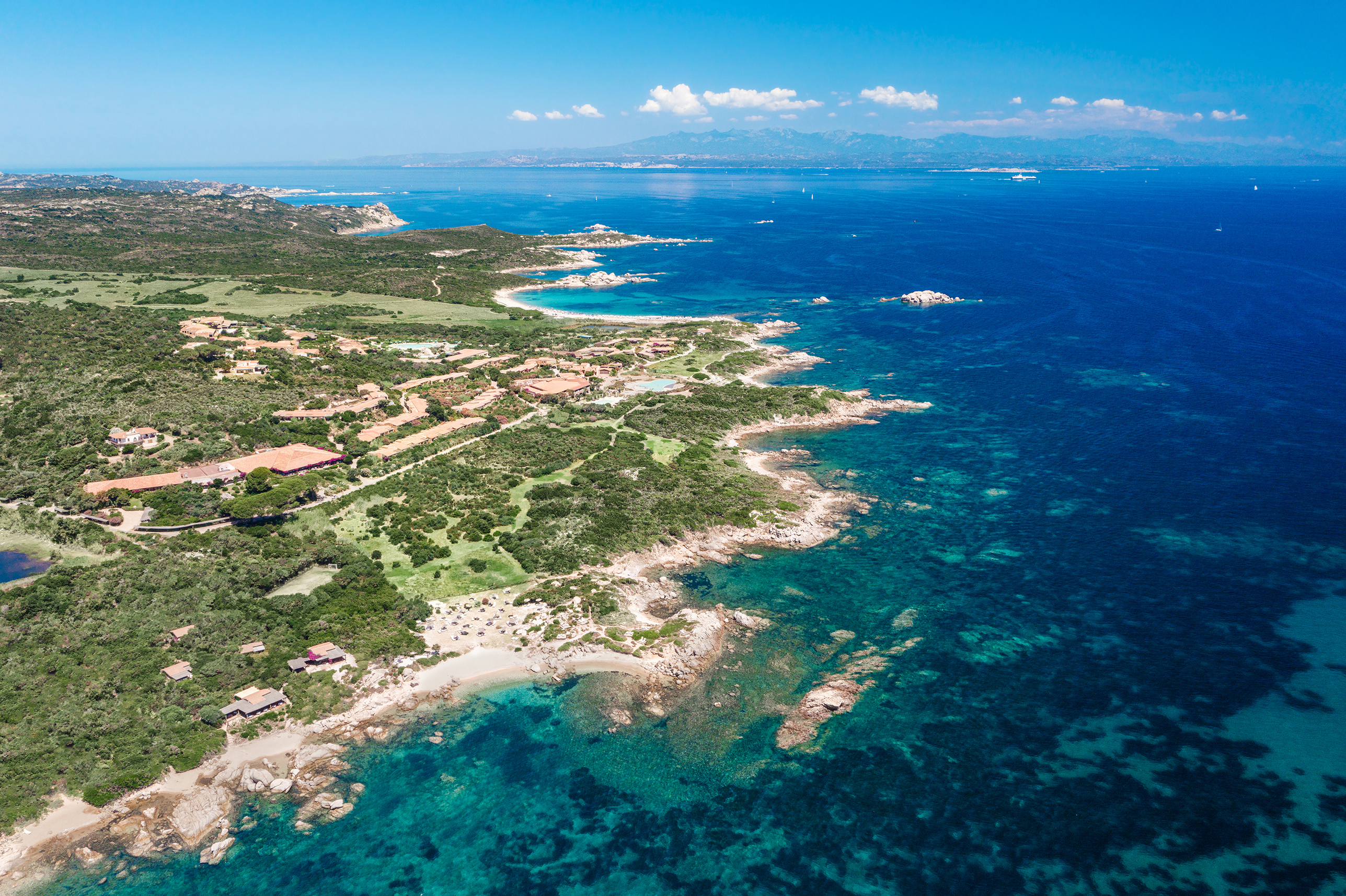 A birds eye view of Valle Dell'Erica Resort and the greenery and ocean that surrounds it
