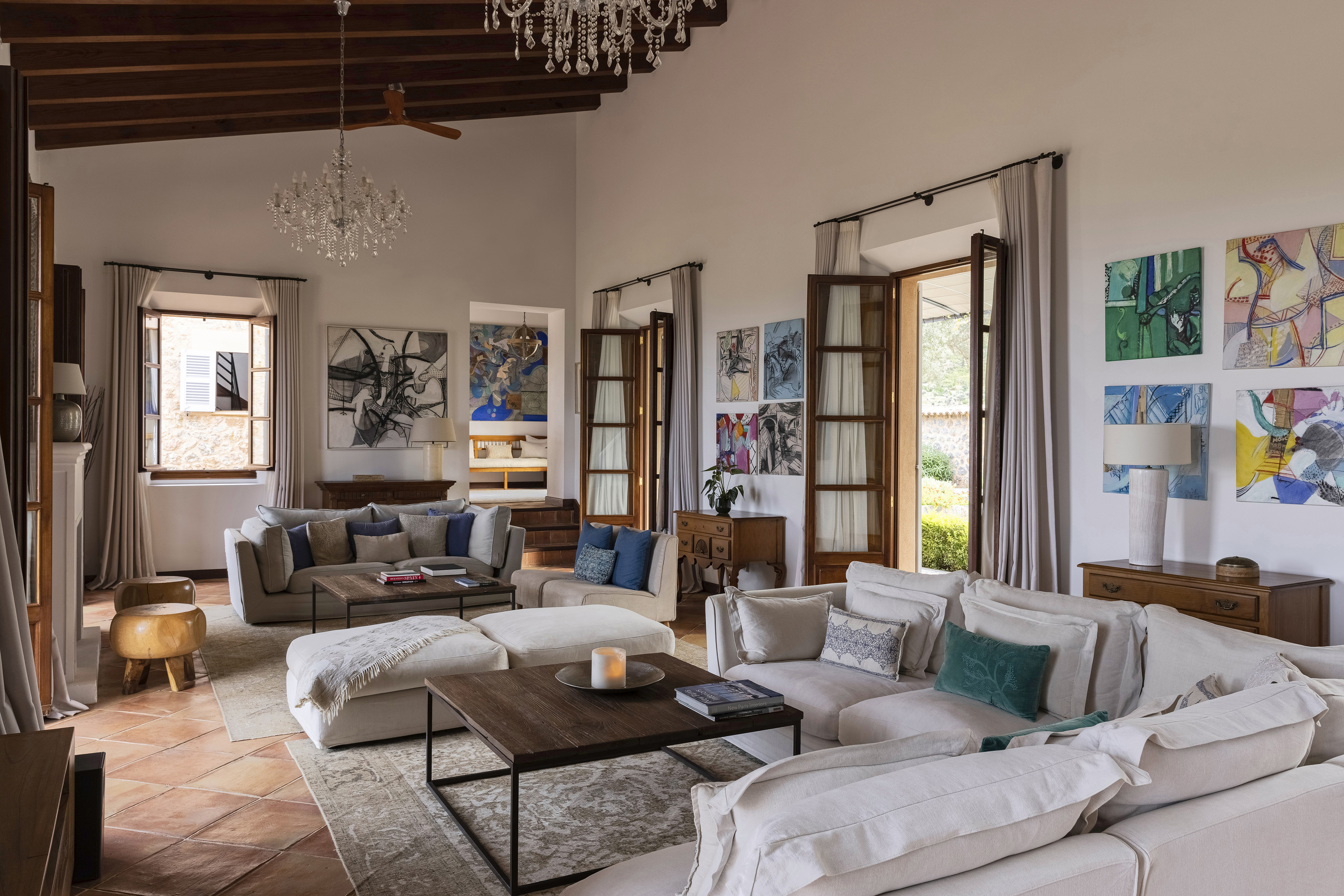 Sa Terra Rotja lounge with colourful paintings and chandeliers 