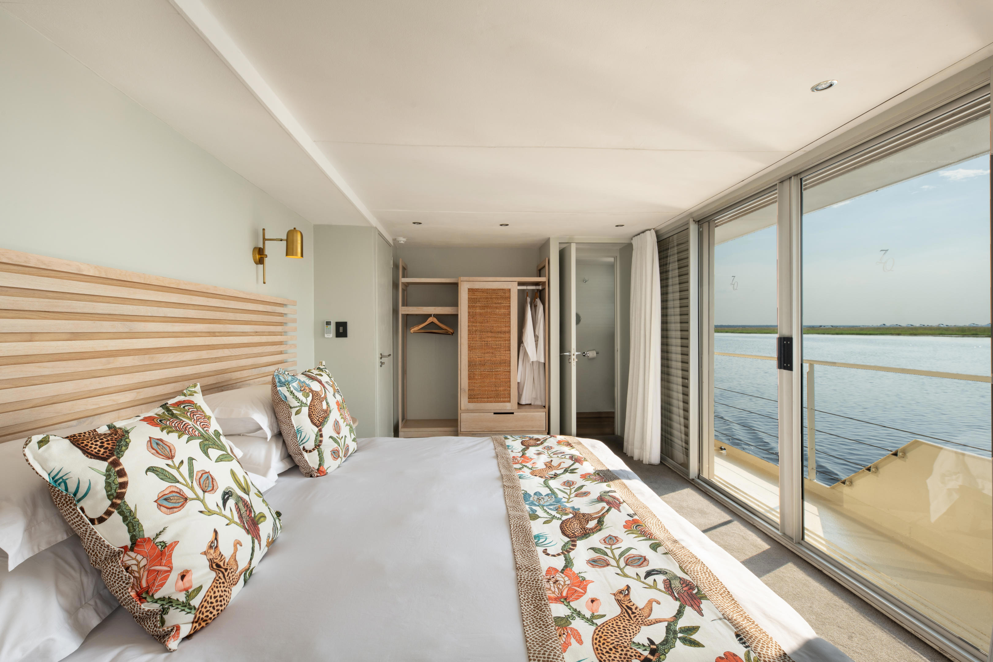 Suite of Zambezi Queen with safari printed cushions and view of river